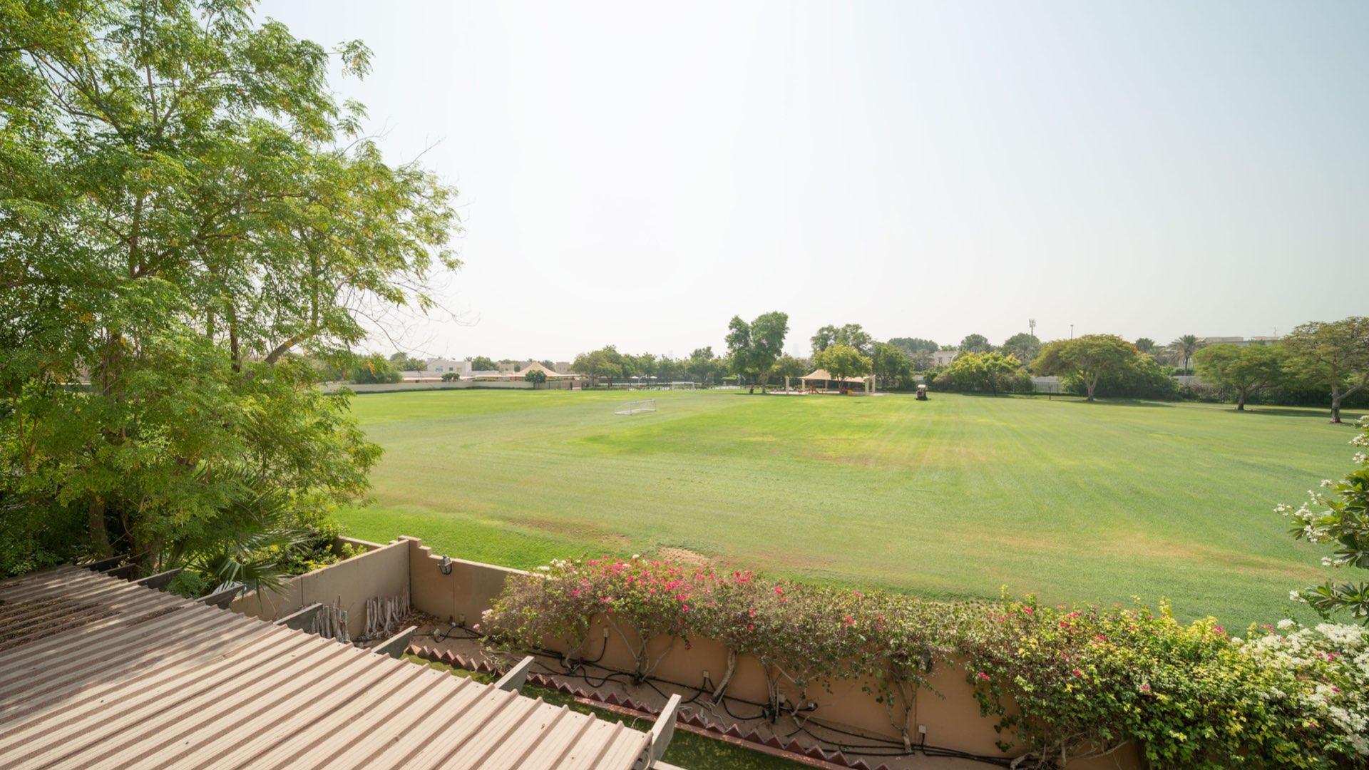 "Spacious villa with landscaped garden view in Hattan, The Lakes community, for sale.",Bright living room with garden view in spacious Hattan villa, The Lakes