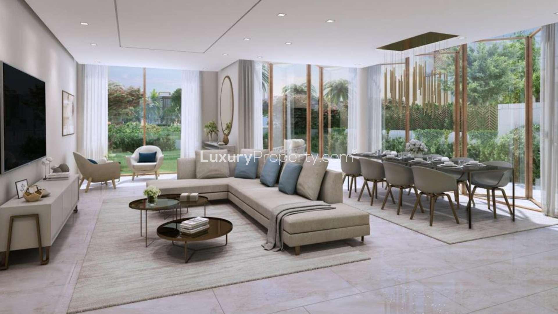 Modern villa exterior on Jumeirah Bay Island with palm trees and landscaped surroundings