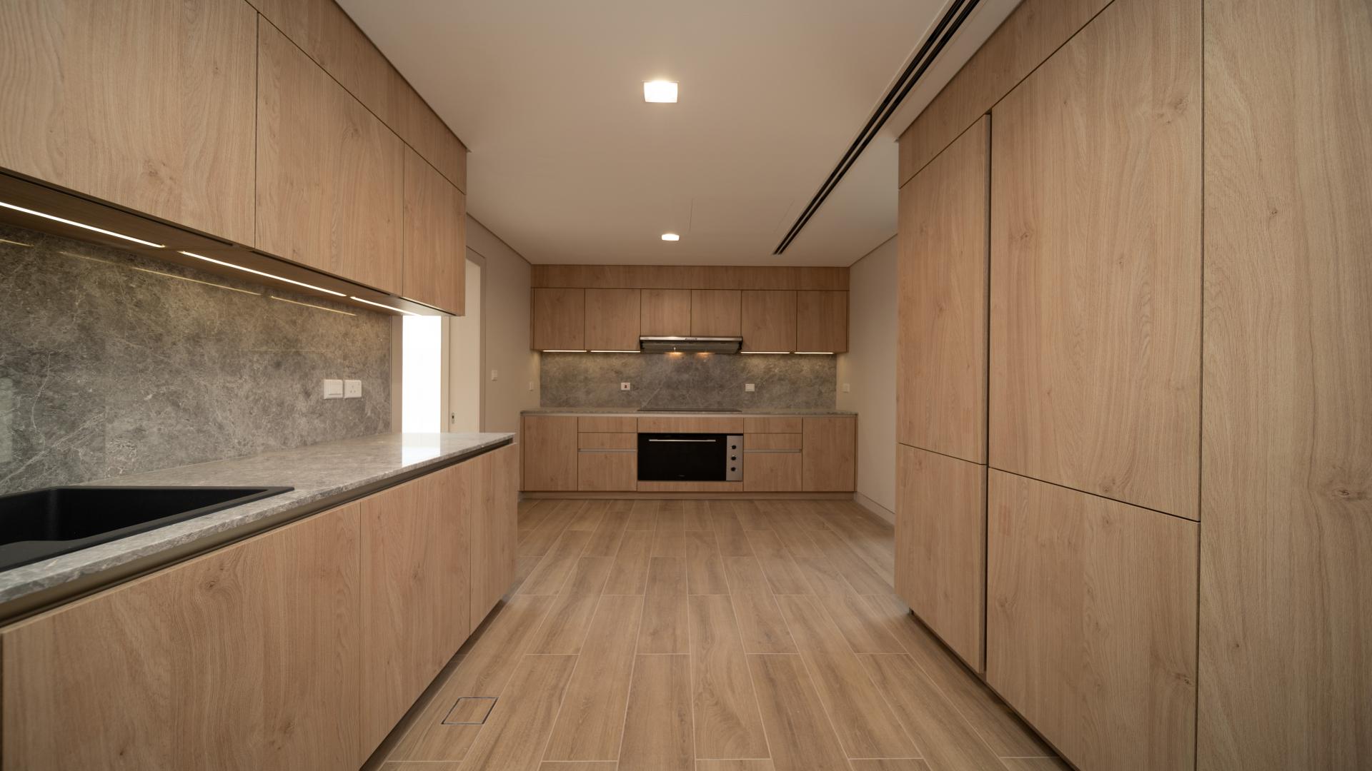 Spacious living area with large windows in Jumeirah Bay Island townhouse for sale