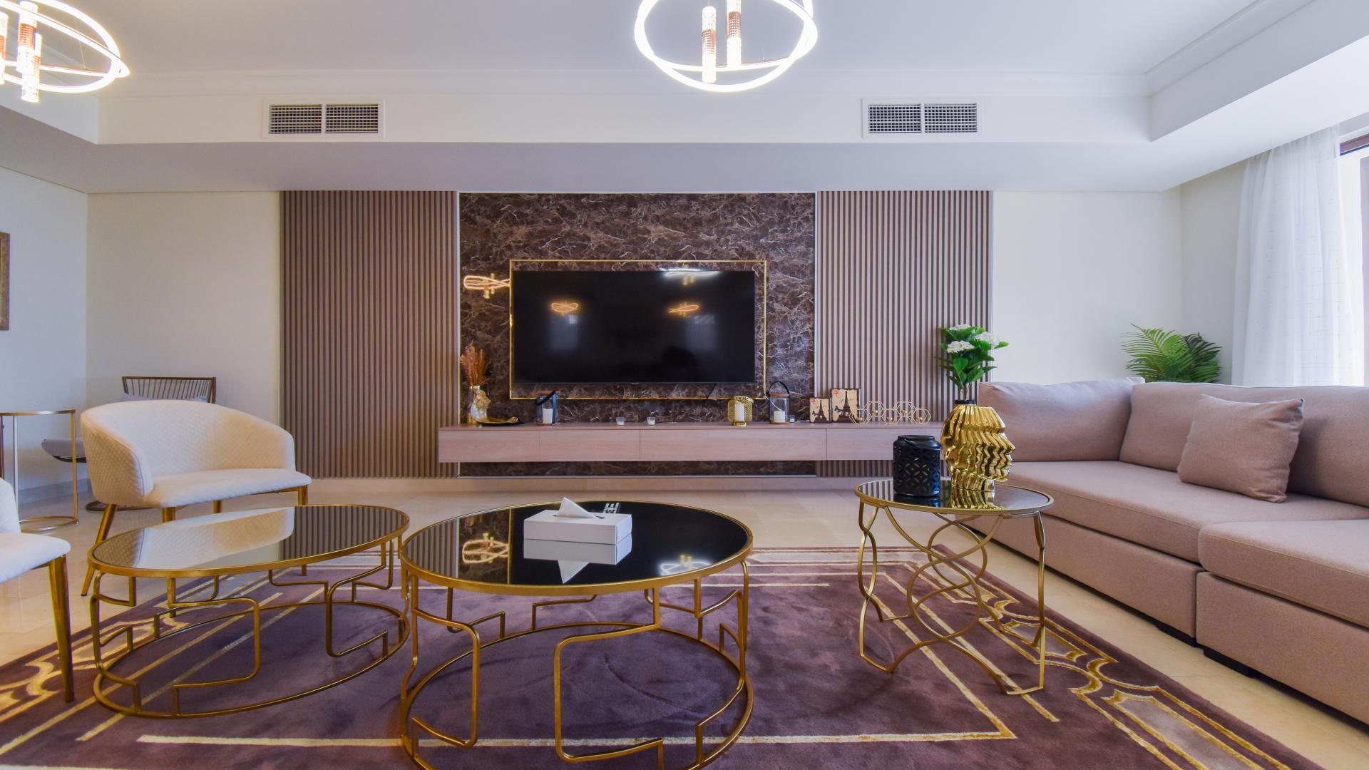 Oceanfront view from Palm Jumeirah villa, showcasing lush greenery and serene waters