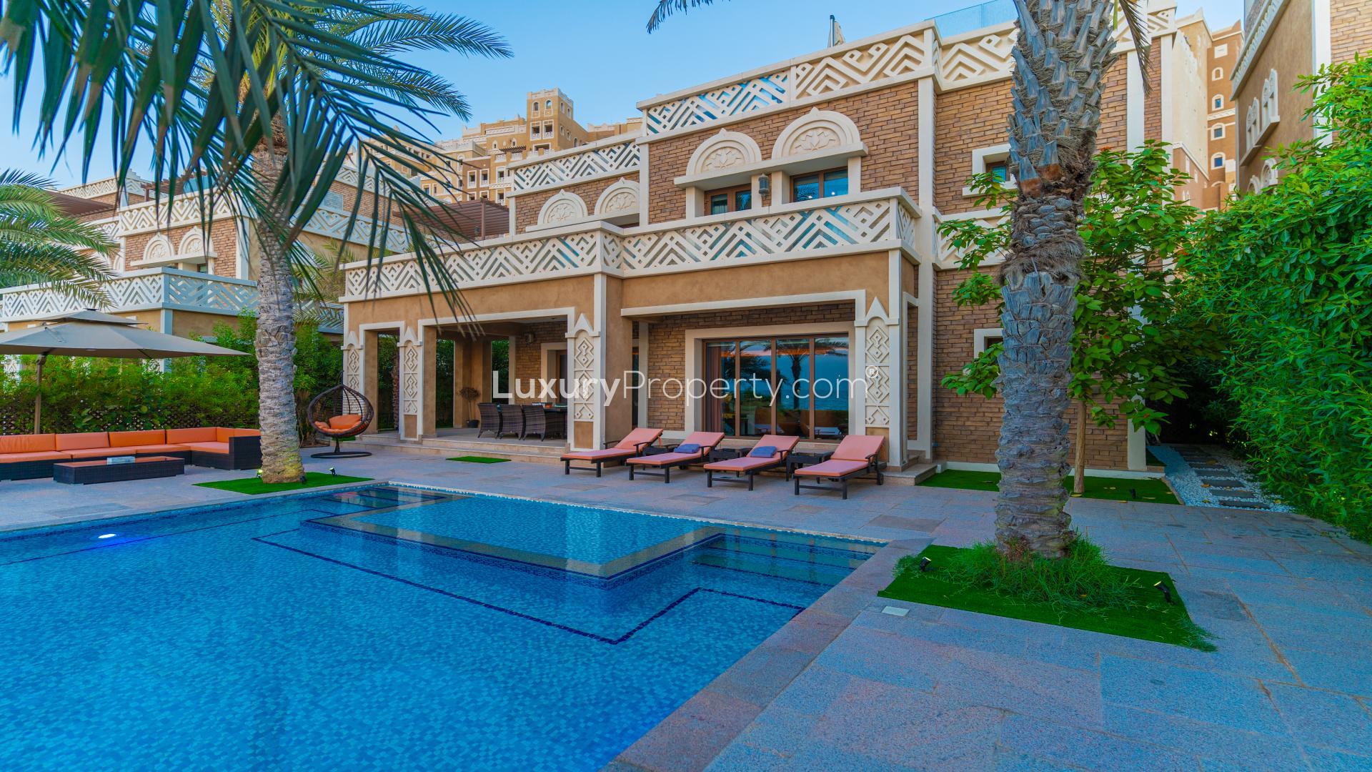 Luxurious living room in 5-bedroom waterfront villa, Palm Jumeirah, with modern decor and sea view