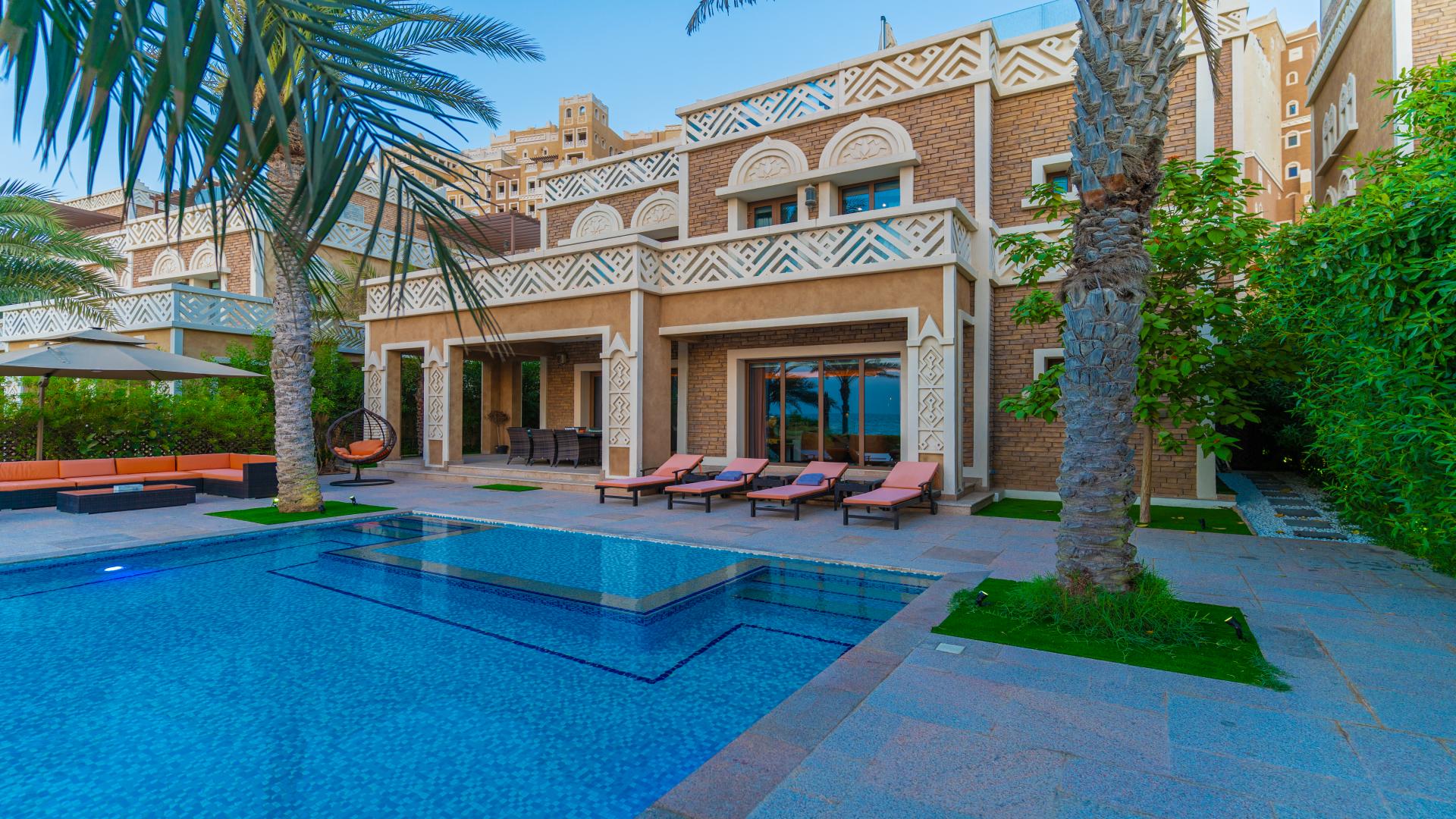 Luxurious living room in 5-bedroom waterfront villa, Palm Jumeirah, with modern decor and sea view