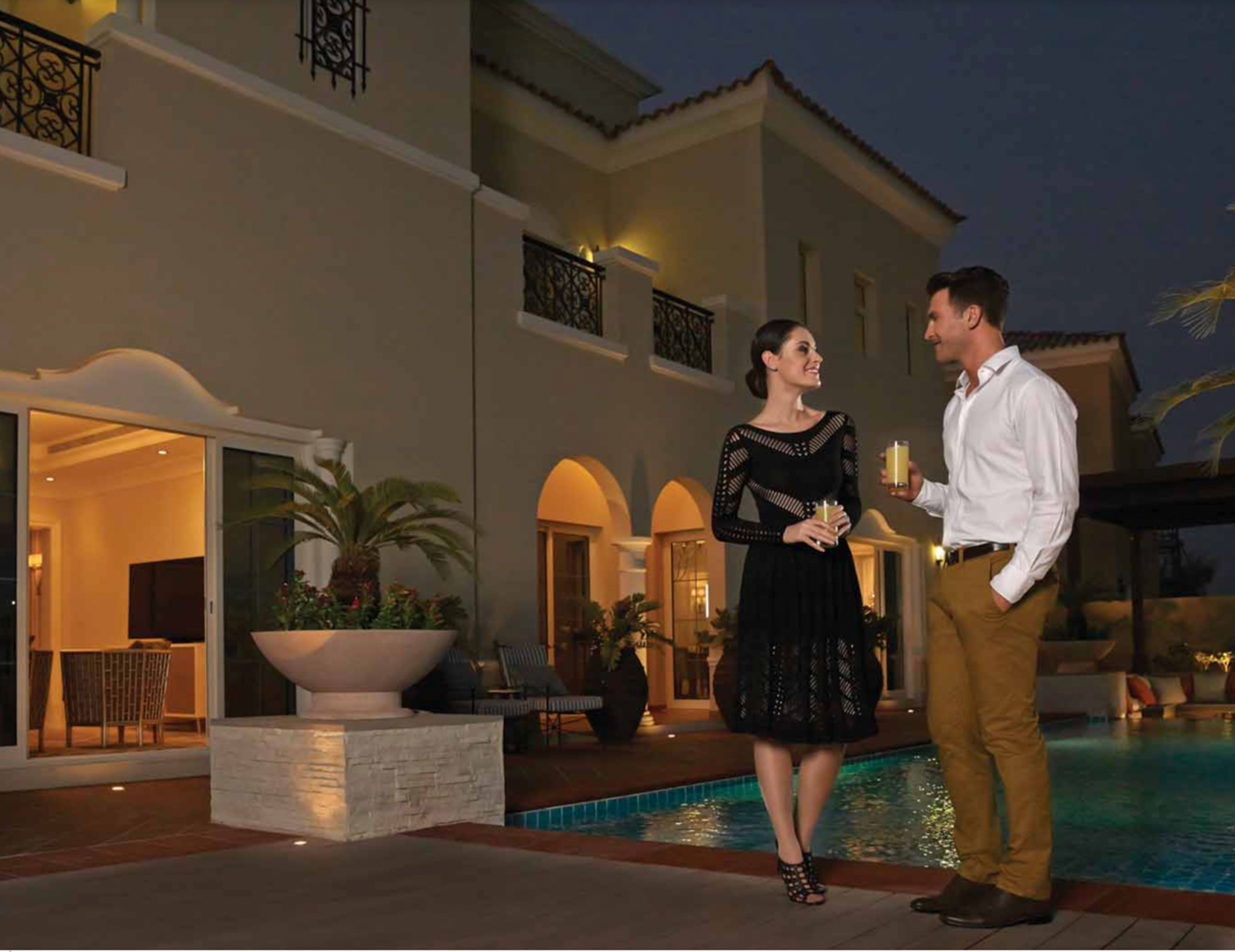 Family enjoying poolside at luxurious villa in La Avenida 2, Arabian Ranches