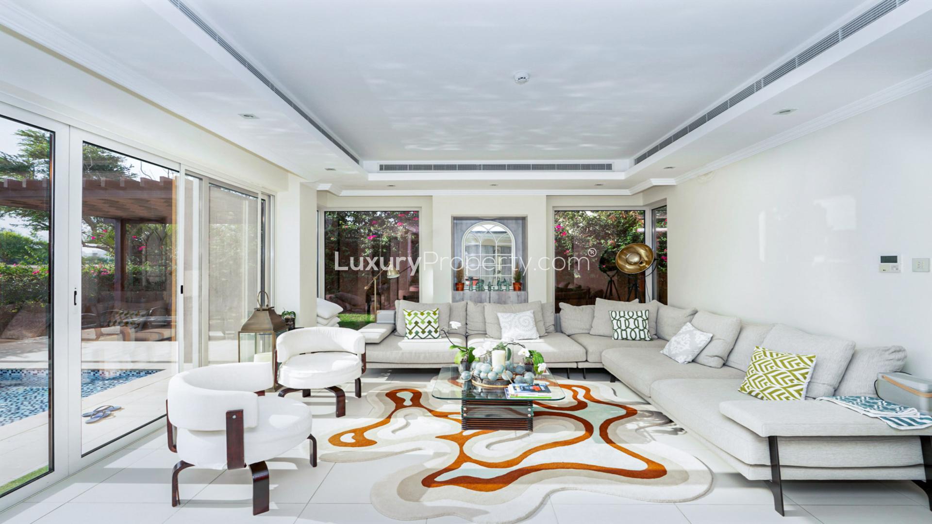 Luxurious open-plan living area in Sienna Views Villa, Jumeirah Golf Estates, with pool view