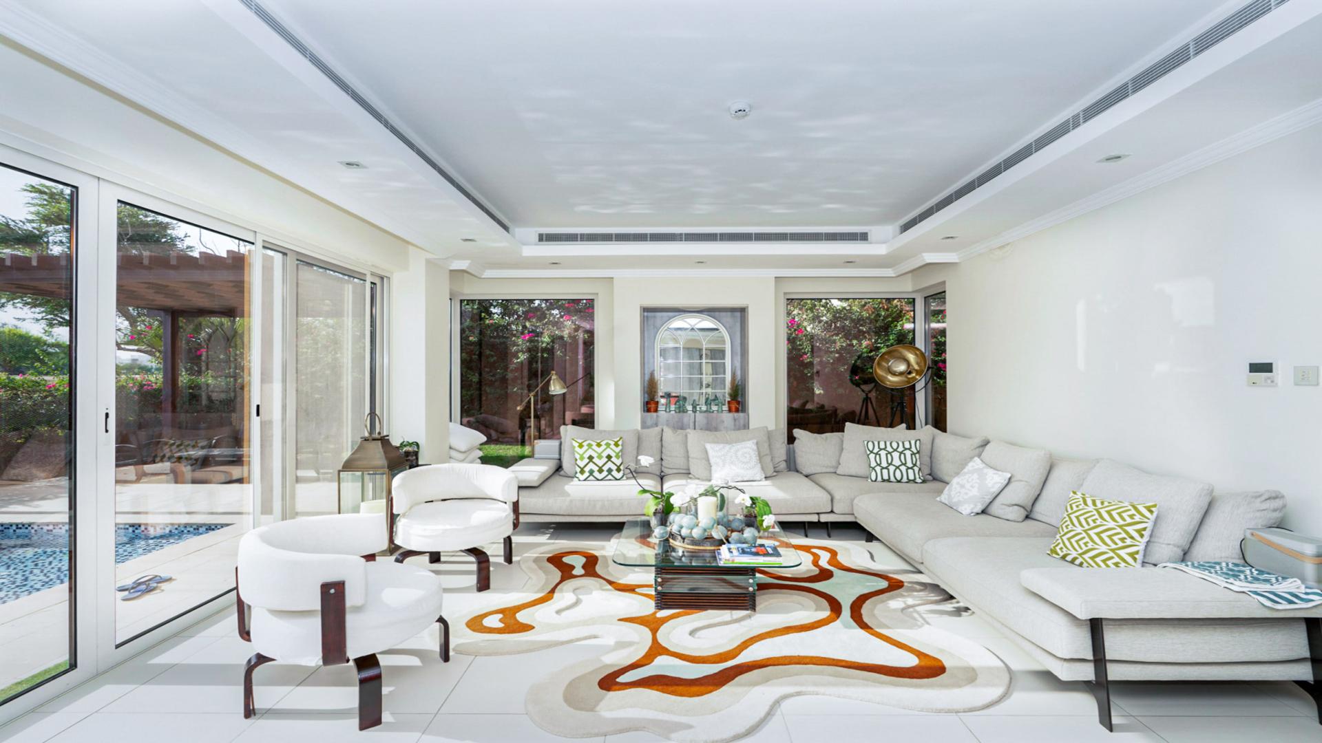 Luxurious open-plan living area in Sienna Views Villa, Jumeirah Golf Estates, with pool view