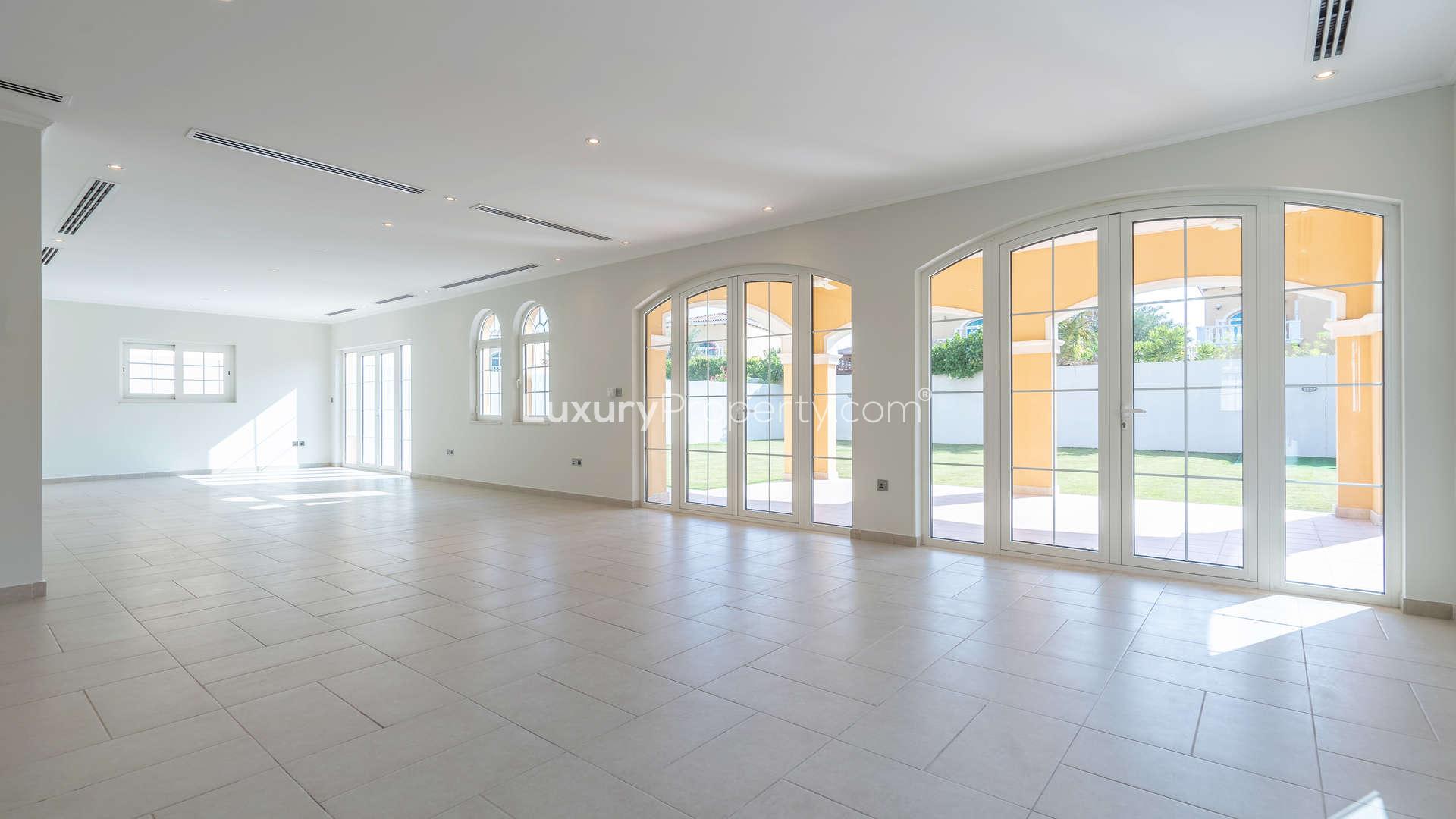 Spacious living room with large windows in Jumeirah Park Legacy villa for sale