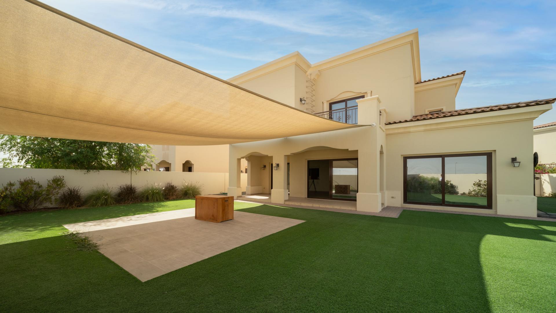 "Spacious backyard of vacant 5-bedroom villa in Arabian Ranches 2, Lila community, for sale.",Empty living room with large windows in villa, Arabian Ranches 2, Lila community