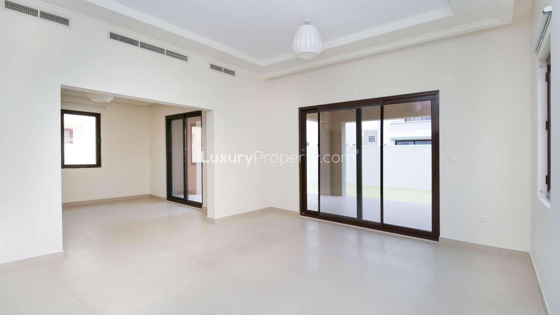 Modern kitchen in 5-bedroom villa, Lila, Arabian Ranches II, with granite countertops and wood cabinets