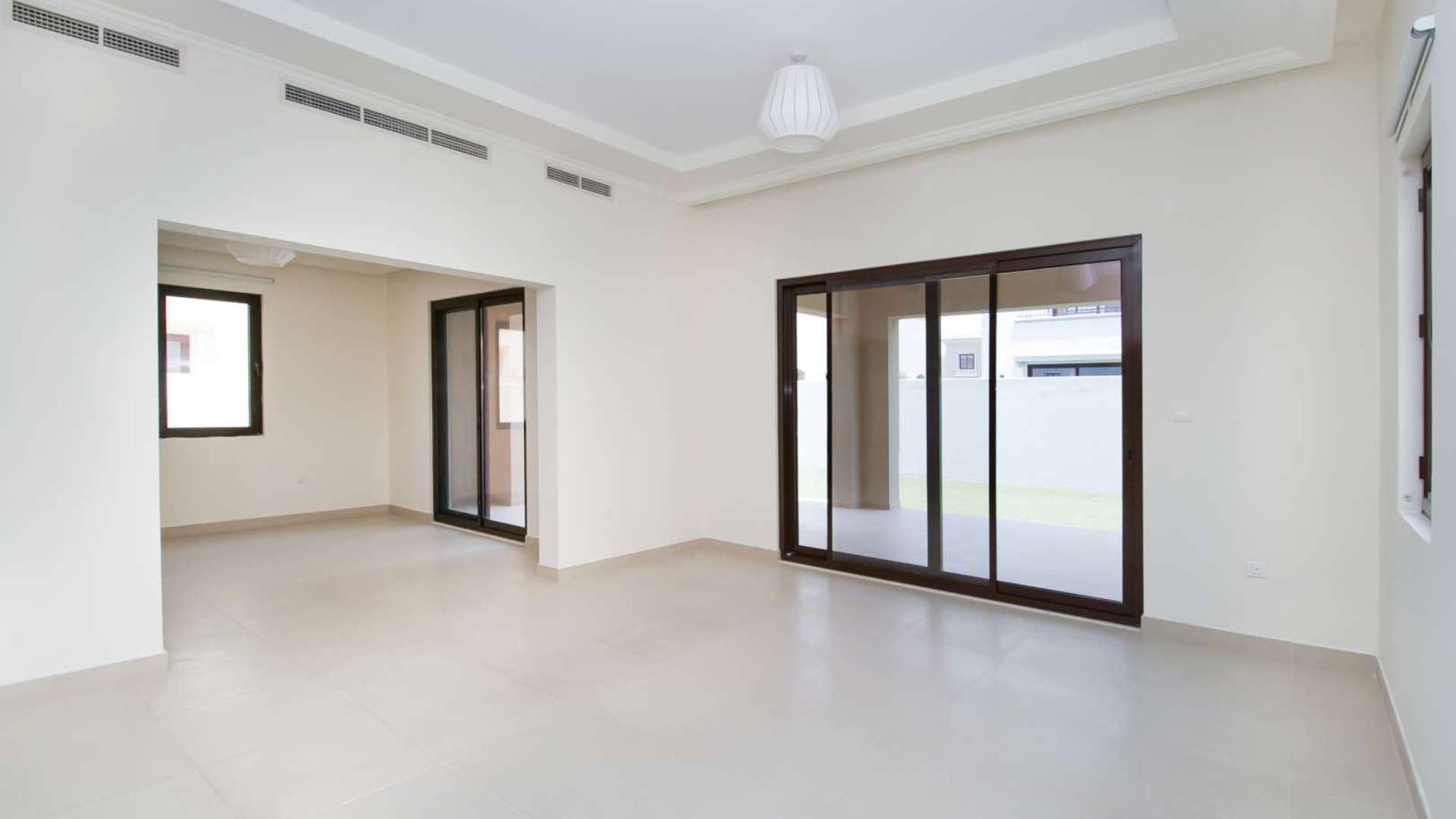 Modern kitchen in 5-bedroom villa, Lila, Arabian Ranches II, with granite countertops and wood cabinets