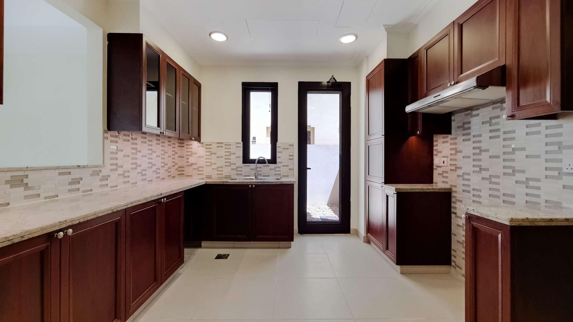 "Balcony view from 5-bedroom villa in Arabian Ranches 2, Lila community, for sale.",Spacious kitchen in 5-bedroom villa, Lila, Arabian Ranches 2, featuring modern cabinetry