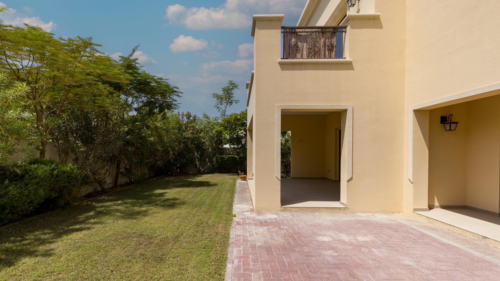 "Spacious living area in 5-bedroom villa, Arabian Ranches 2, with garden view through glass doors.",Corner plot villa with mature garden in Arabian Ranches 2, Lila community