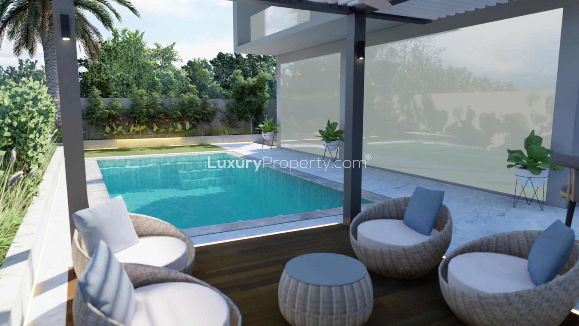 Luxurious villa pool with pergola seating in Tilal Al Ghaf, Harmony 3 community