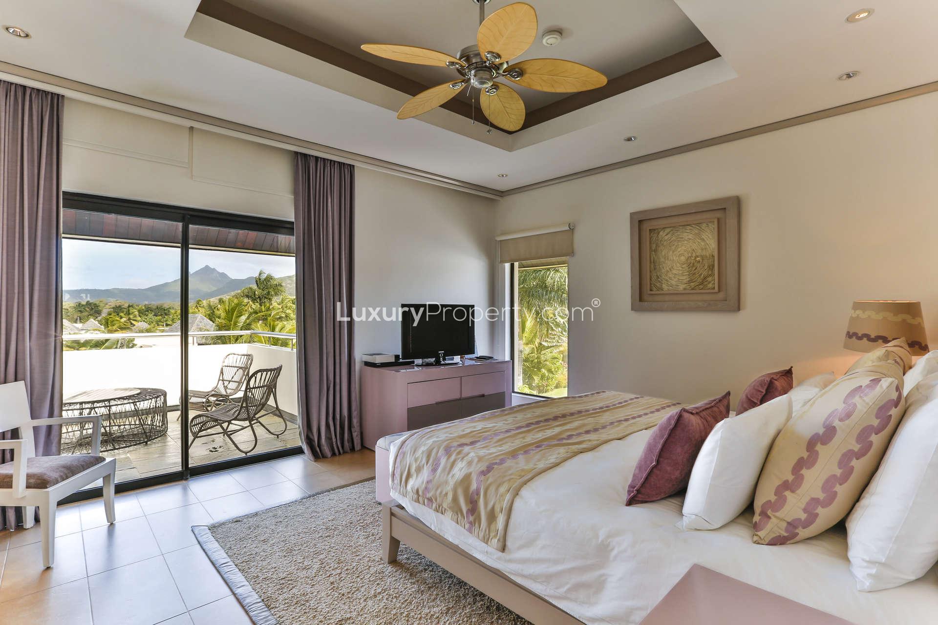 Luxurious outdoor living area with pool view in Anahita, Mauritius villa for sale
