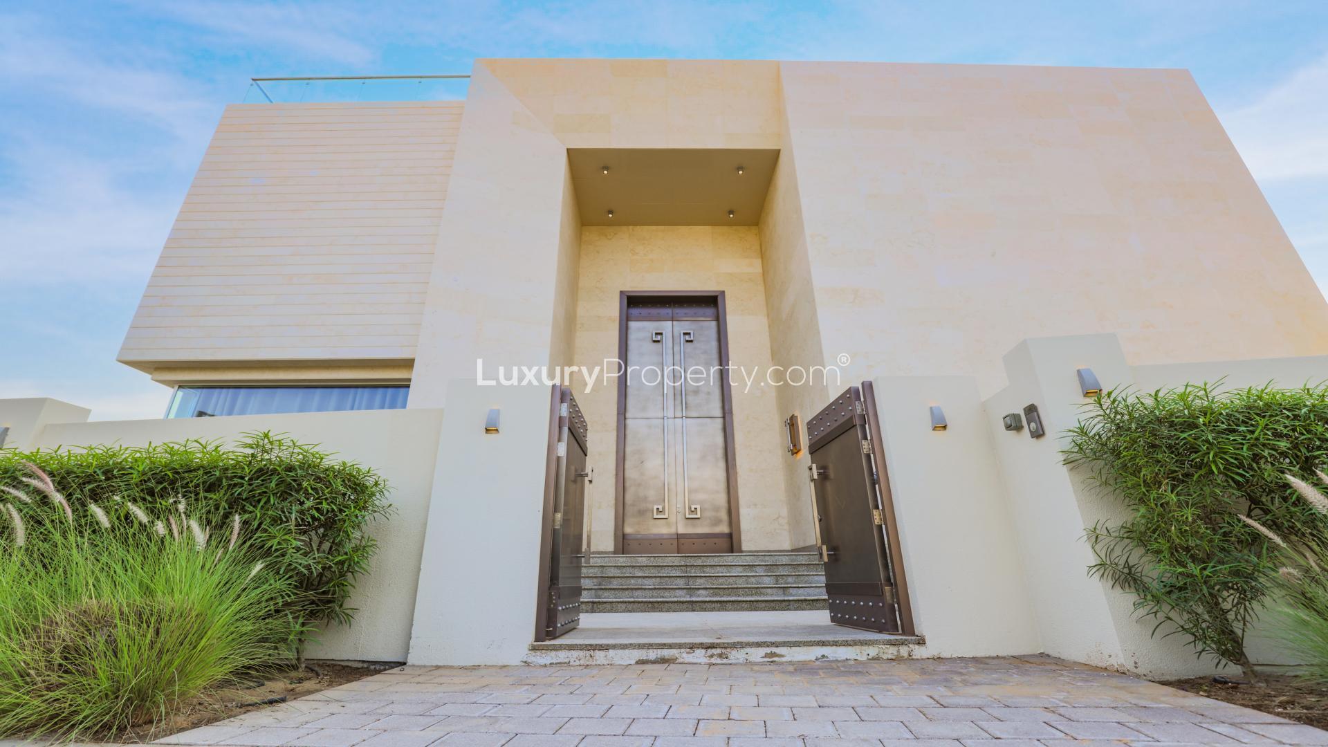 "Modern entrance of luxury villa for sale, Dubai Hills Estate, contemporary design, illuminated facade.",Front entrance of modern villa in Dubai Hills Estate for sale, LP16338
