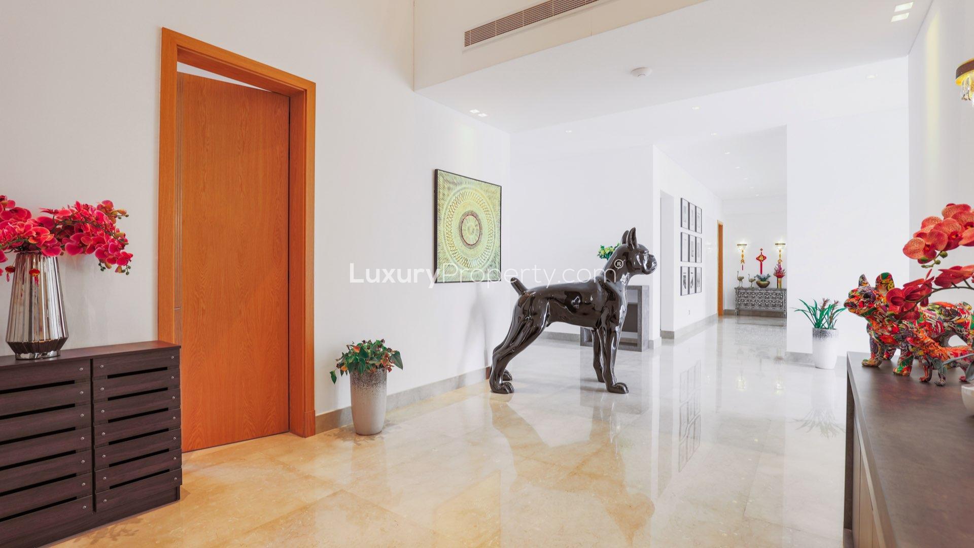 Modern villa entrance with contemporary decor in Dubai Hills Estate, featuring elegant sculptures and art