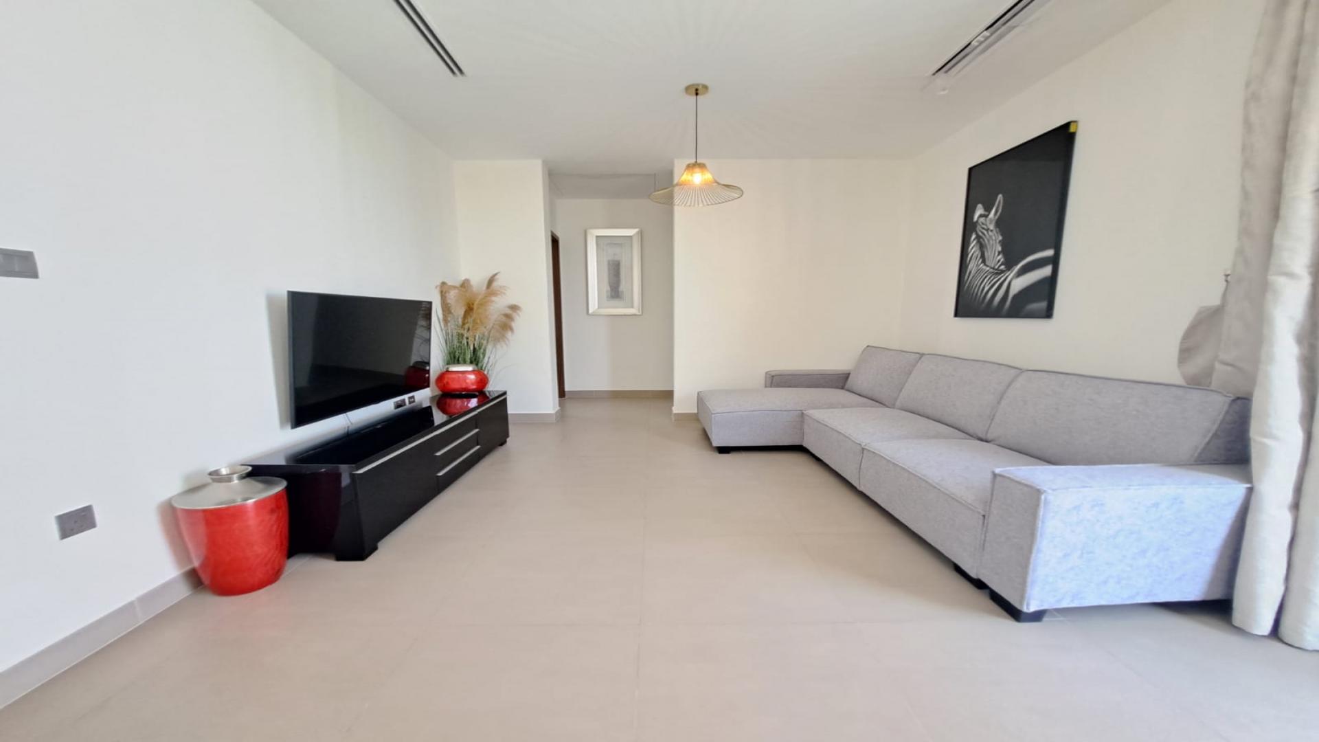 Modern living room in Sidra Villas III, Dubai Hills Estate, with elegant dining area