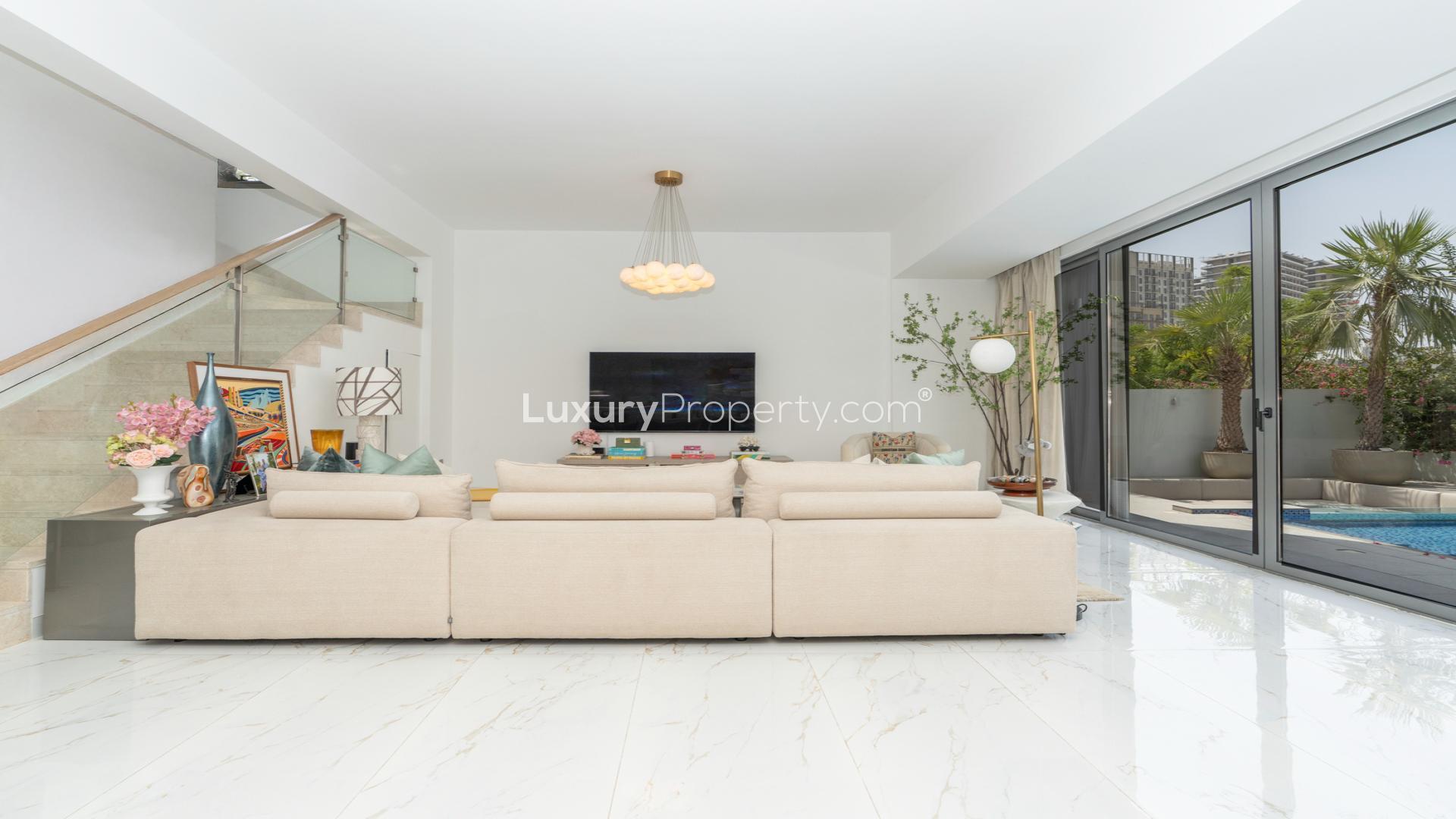 Modern living room with pool view in Sidra 1, Dubai Hills Estate villa
