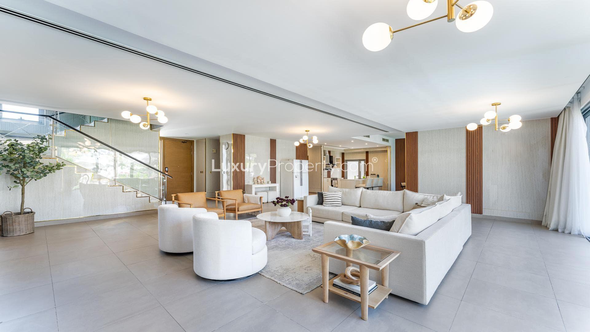 Modern living room in upgraded Sidra Villas II, Dubai Hills Estate, overlooking park and pool