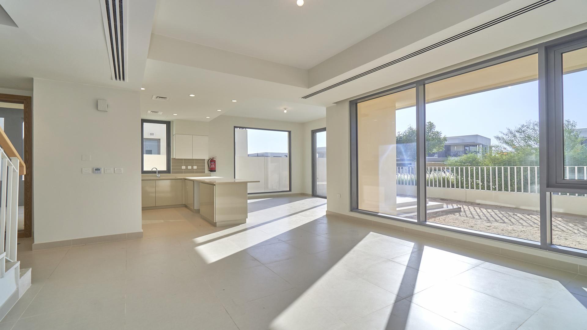 Dubai Hills Estate townhouse view with garden and community park in Maple sub-community