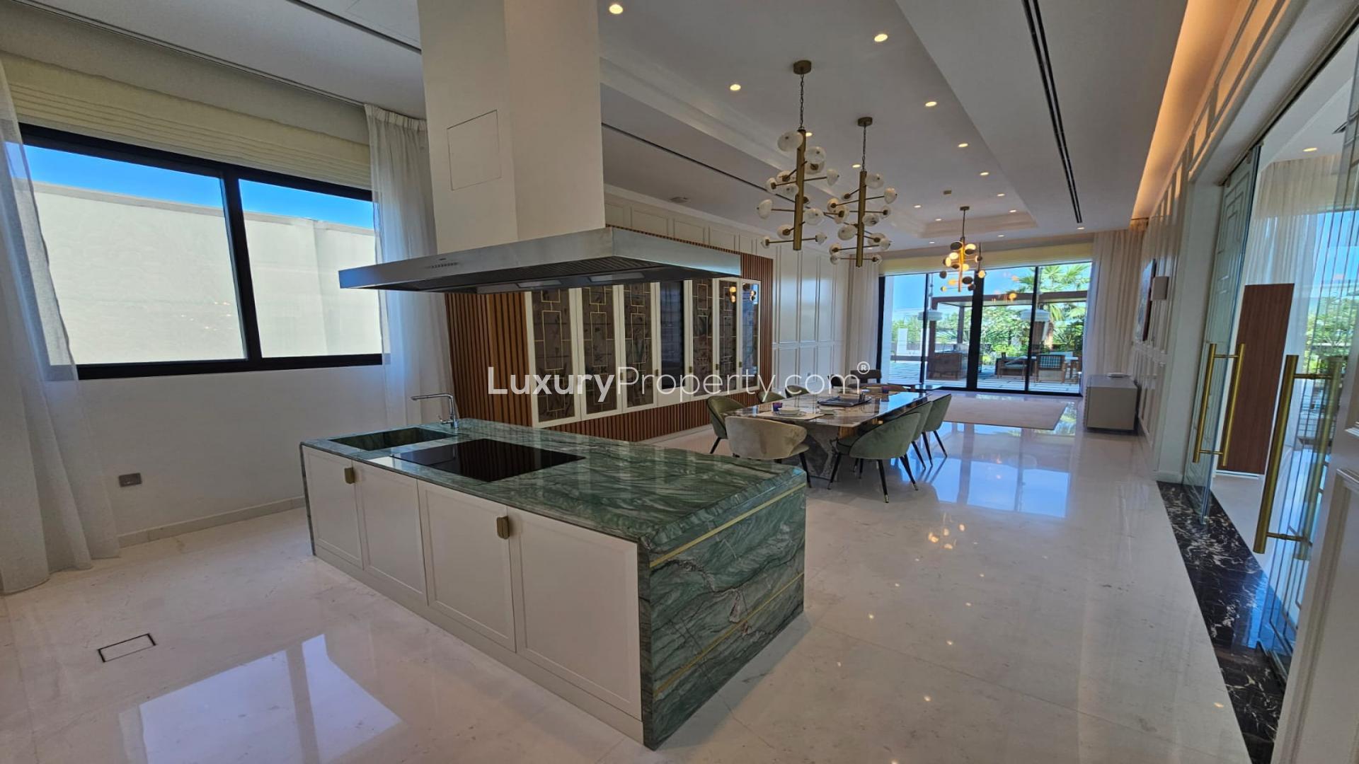 "Spacious dining area in furnished mansion, Dubai Hills Estate, with garden view and elegant decor.",Luxurious kitchen and dining area in bespoke Dubai Hills Estate mansion with park view