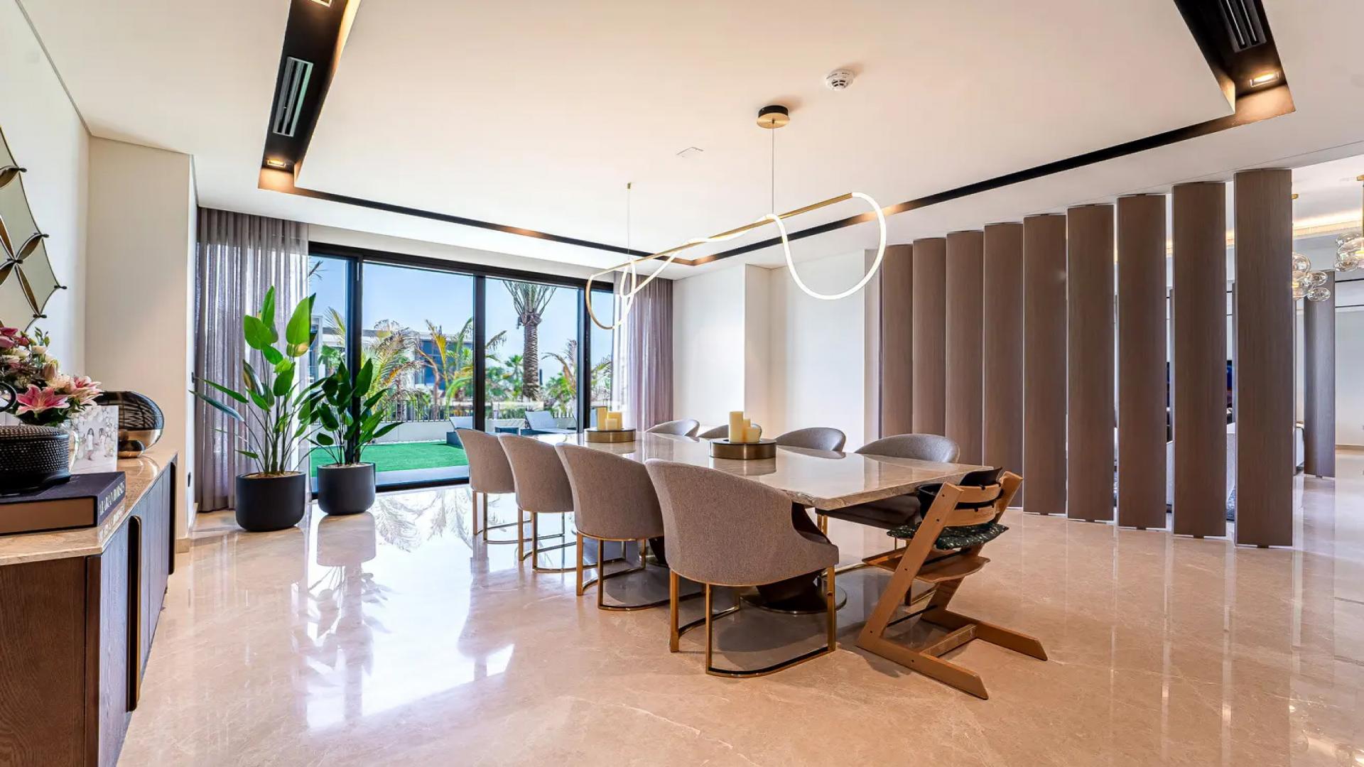 Modern kitchen in a 5-bedroom villa, Dubai Hills Estate, with garden view and elegant decor