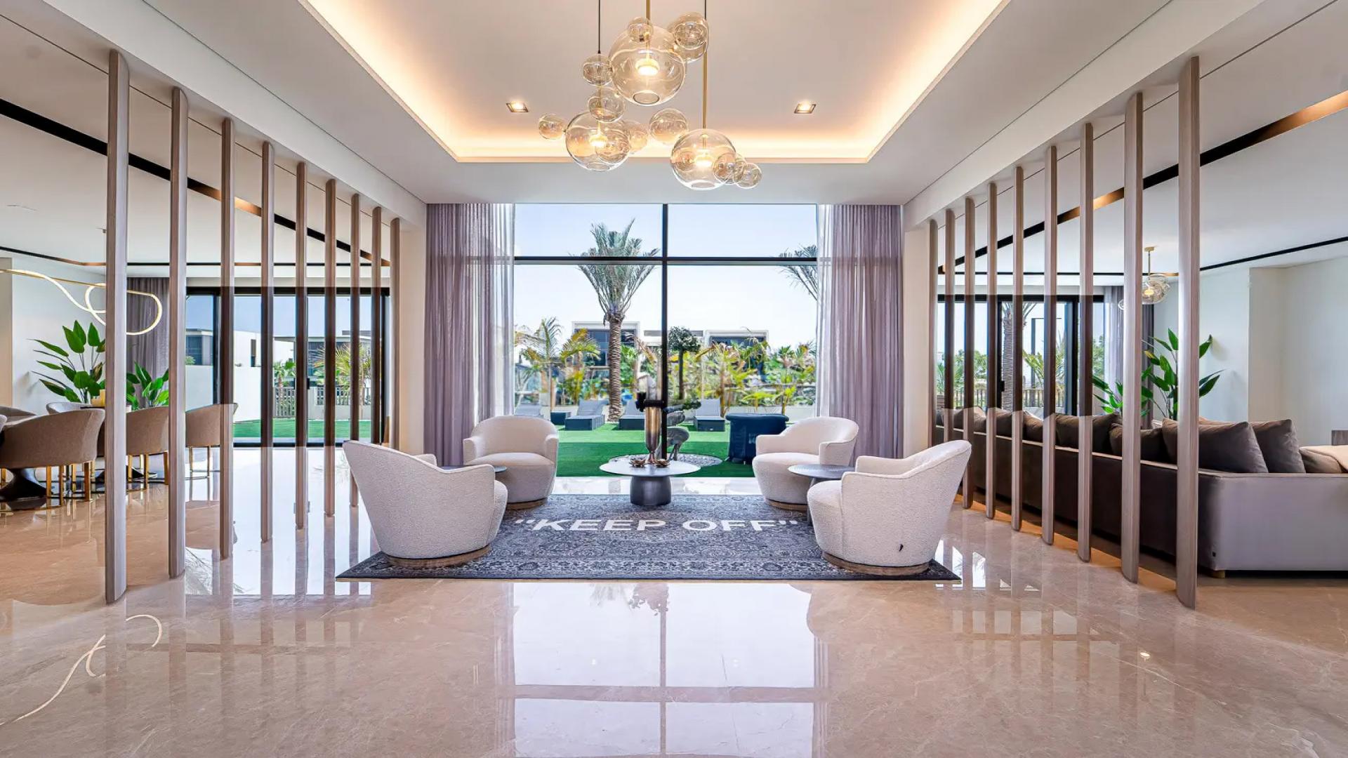 Luxurious living room in 5-bedroom villa, Dubai Hills Estate, with modern decor and garden view