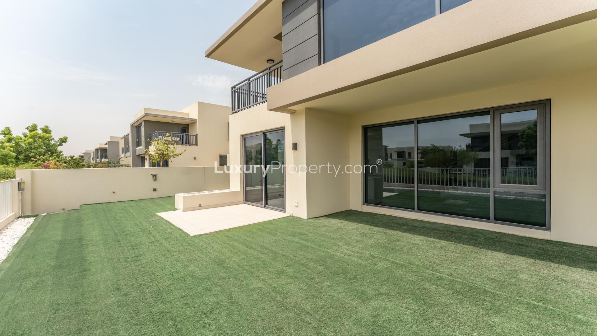 Modern open-plan living area in Maple villa, Dubai Hills Estate with large windows and garden view