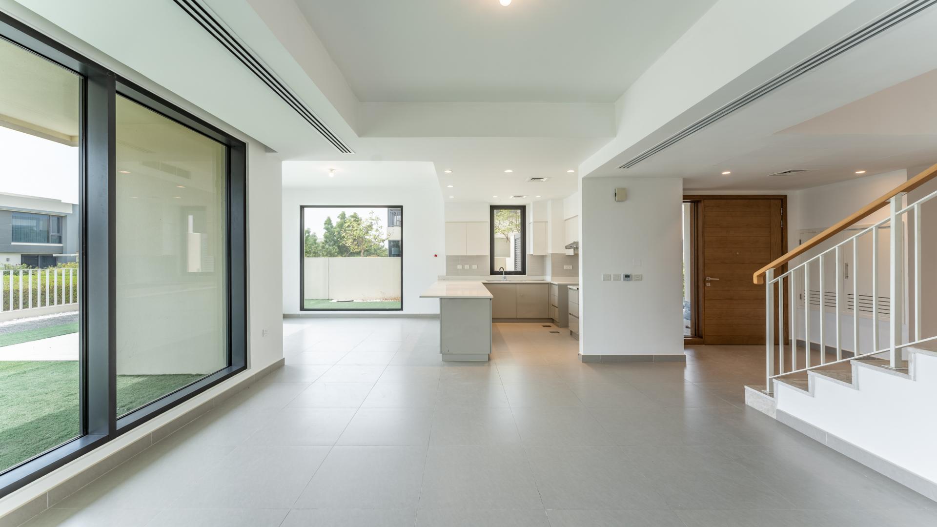 "Spacious villa patio in Maple at Dubai Hills Estate, ideal for outdoor living, LP39246.",Open-plan living area in Maple villa, Dubai Hills Estate, featuring modern kitchen and large windows