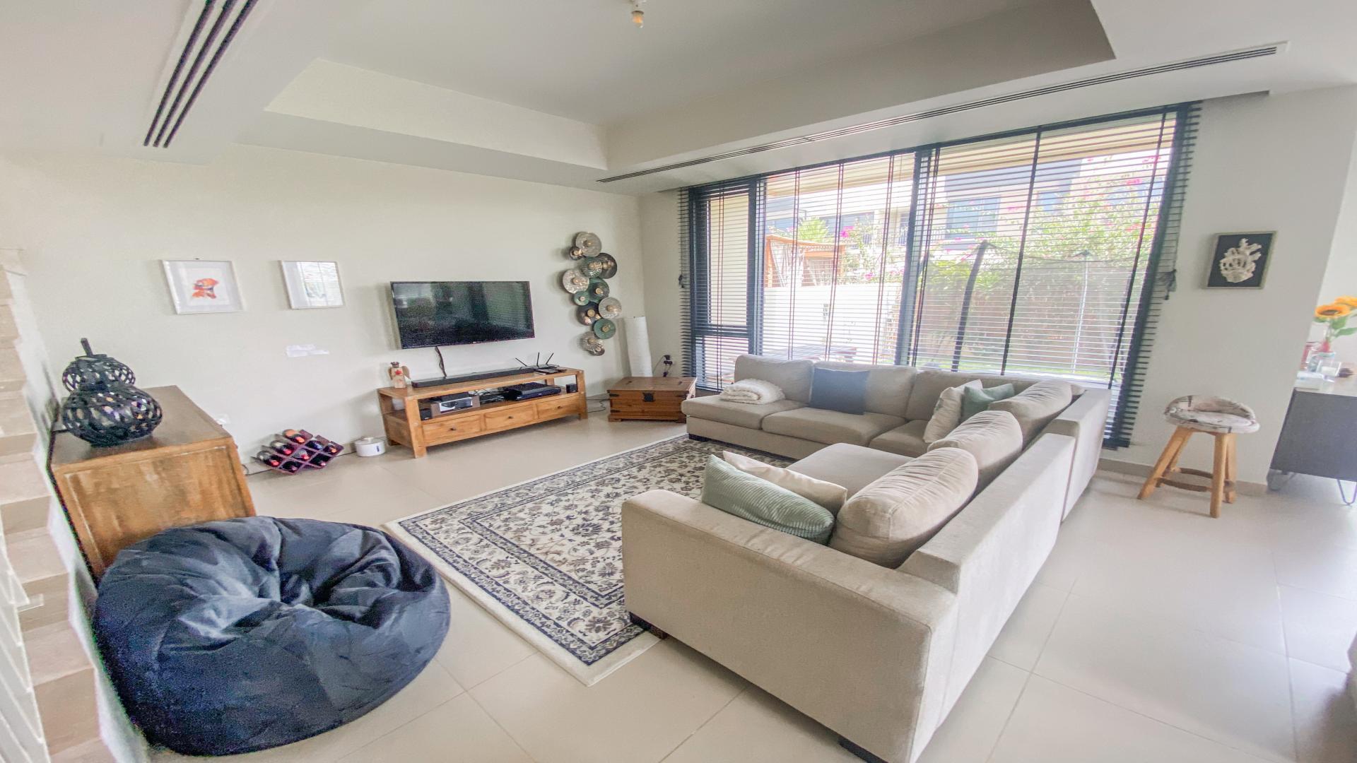 Luxurious living room in Dubai Hills Estate villa, featuring modern decor and spacious layout