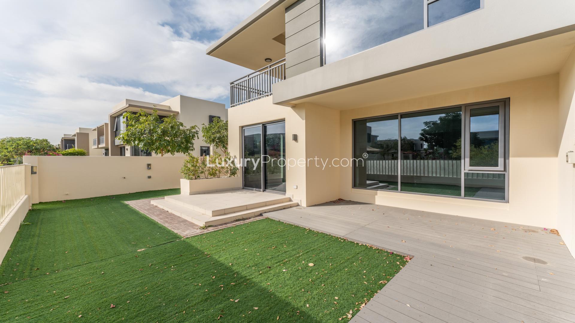 Spacious living room with large windows in Dubai Hills Estate villa for sale