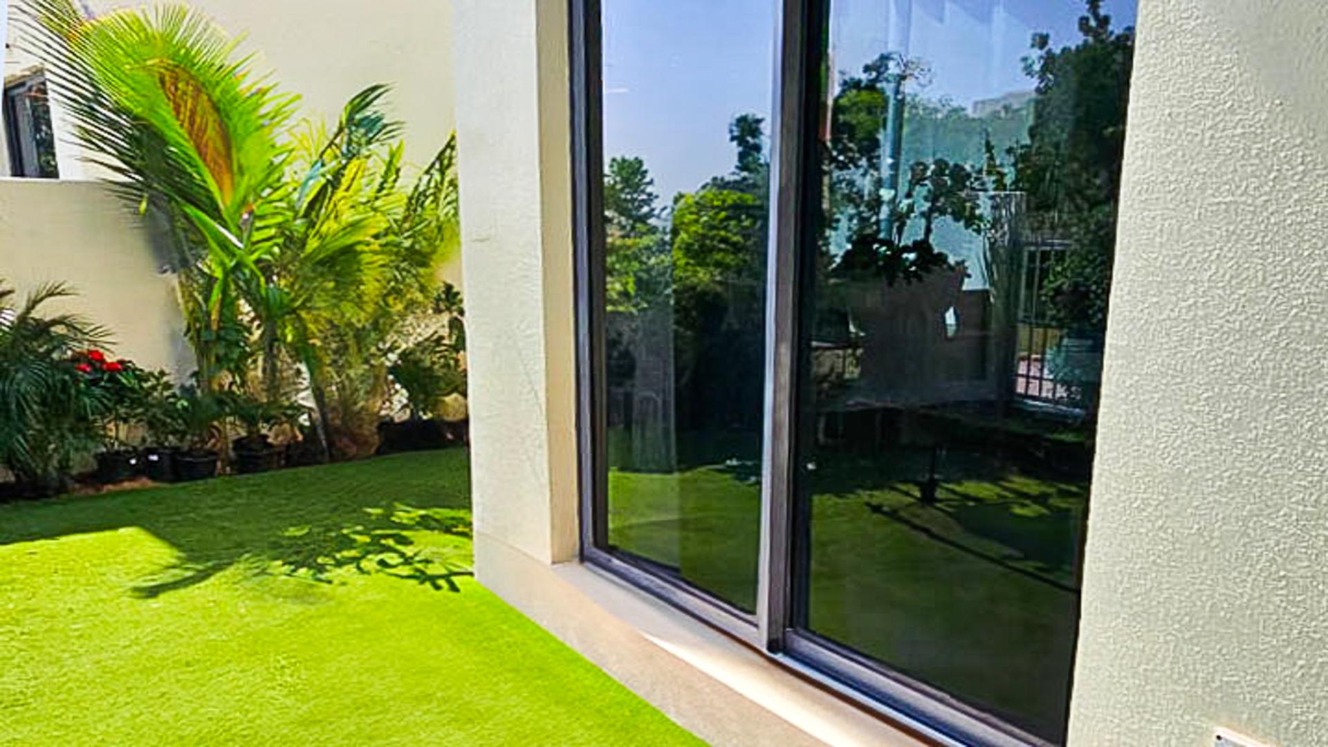 Living room in 5-bedroom Maple Villa, Dubai Hills Estate, with garden view and modern decor