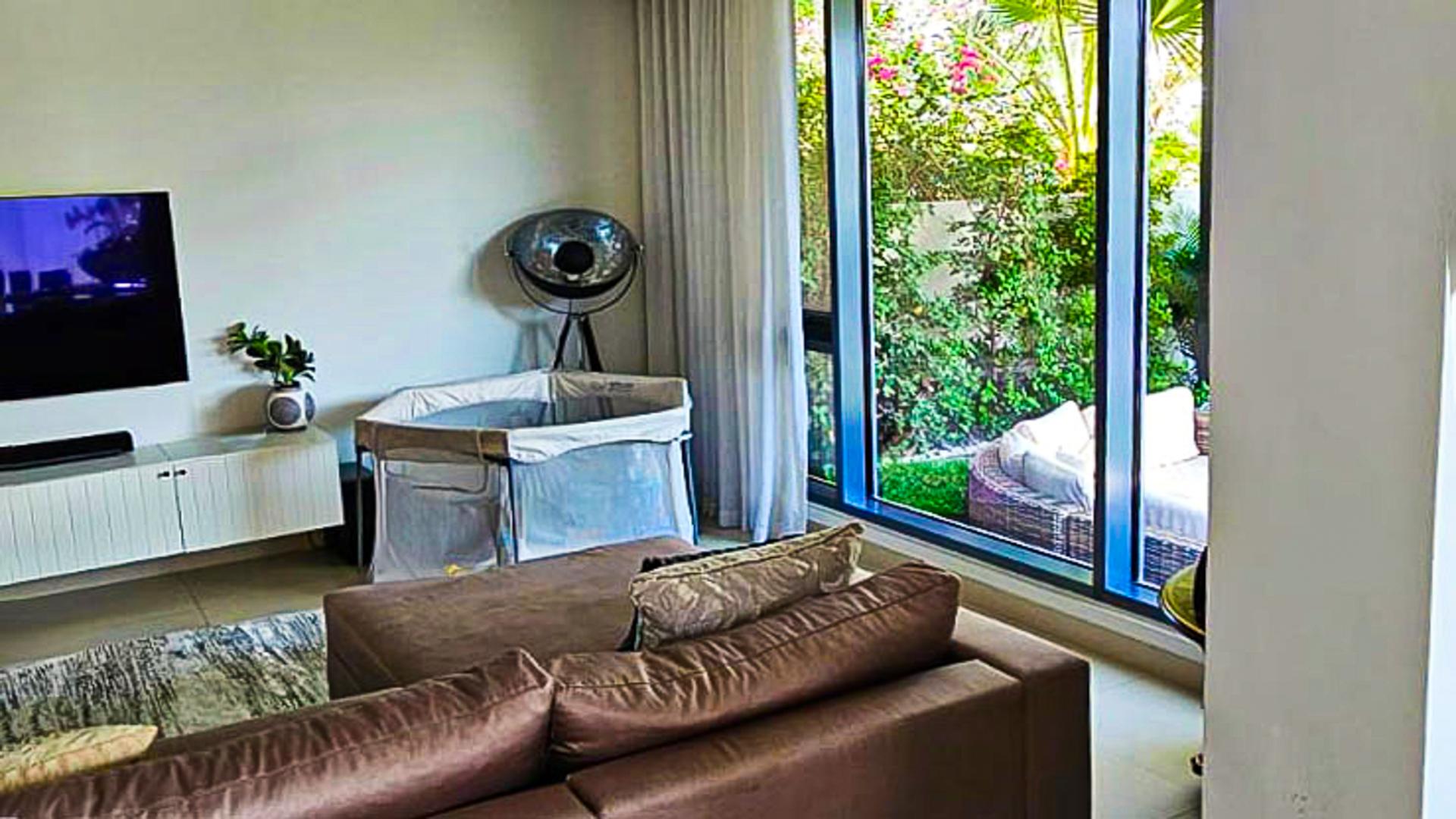 Covered outdoor patio in Maple Villa, Dubai Hills Estate, with seating and garden views