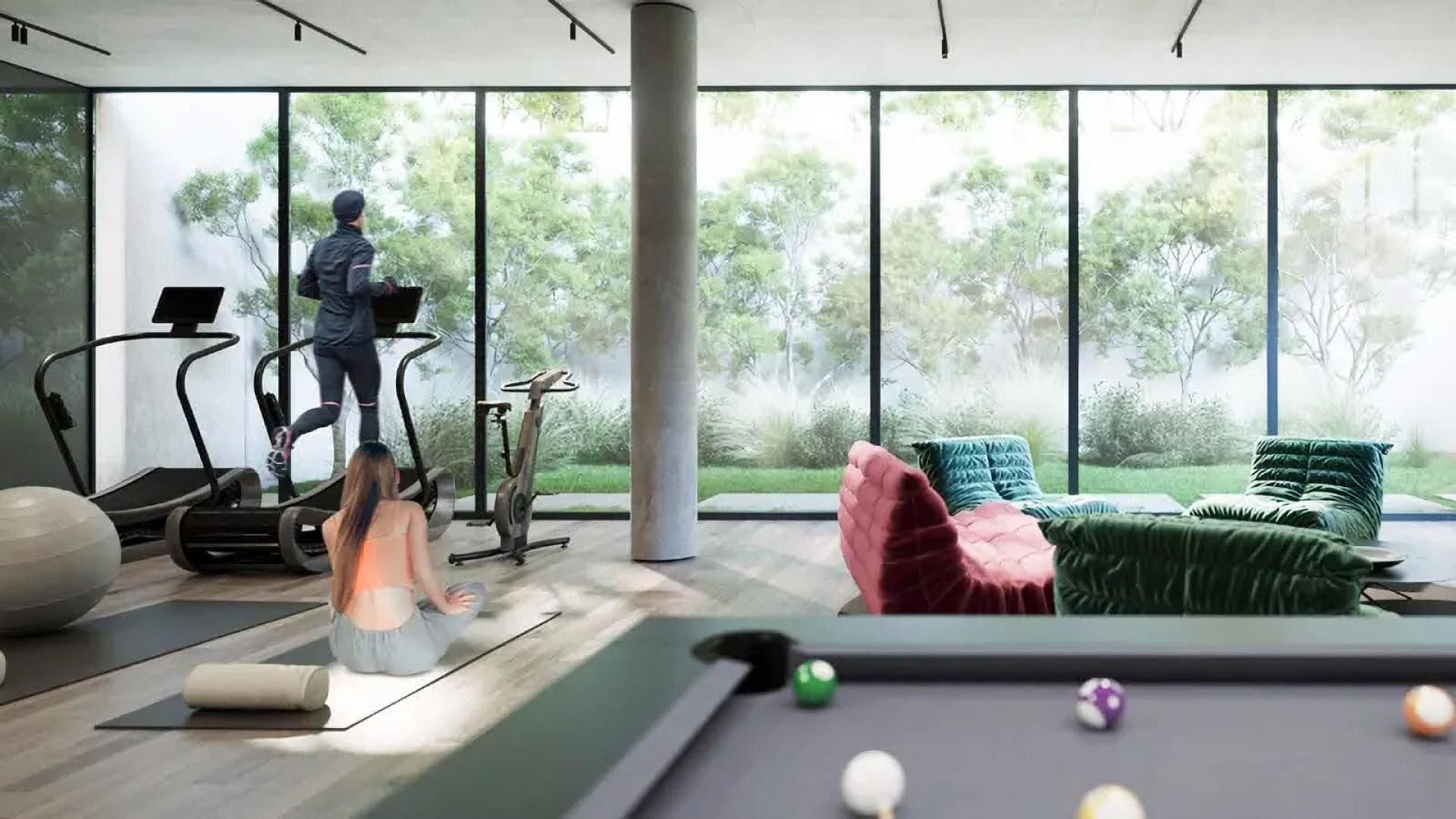 Modern villa interior in Jouri Hills, Jumeirah Golf Estates, featuring sleek staircase and lounge chair