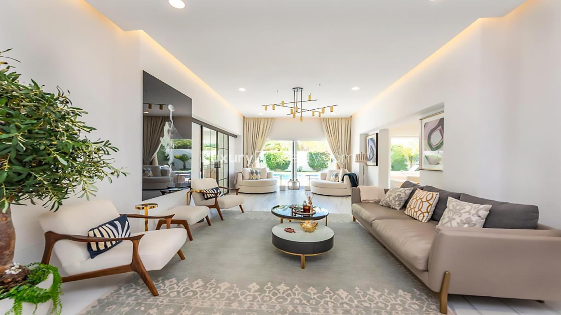 Elegant living room in 5-bedroom villa, Meadows 2, with pool view and modern decor