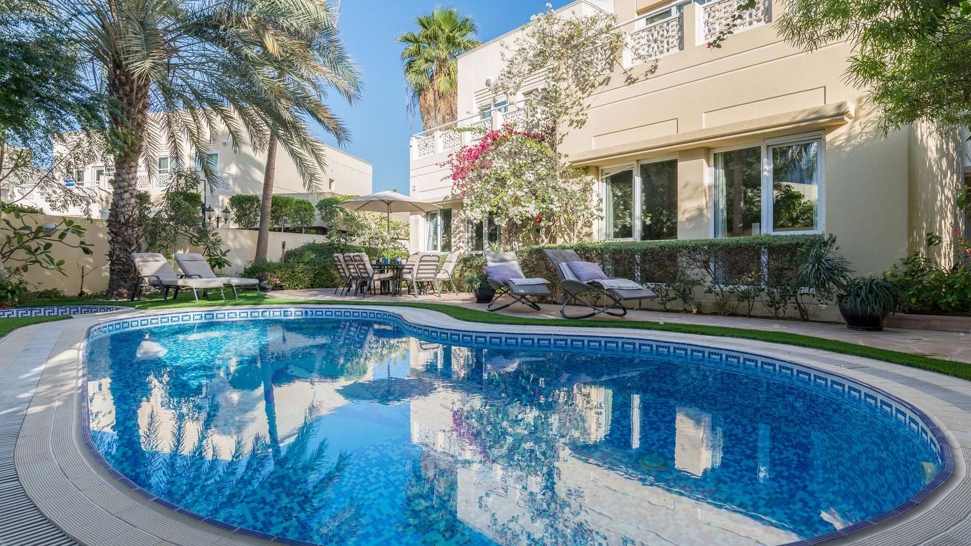 Front view of 5-bedroom villa in Meadows 1, Emirates Living, with lush greenery