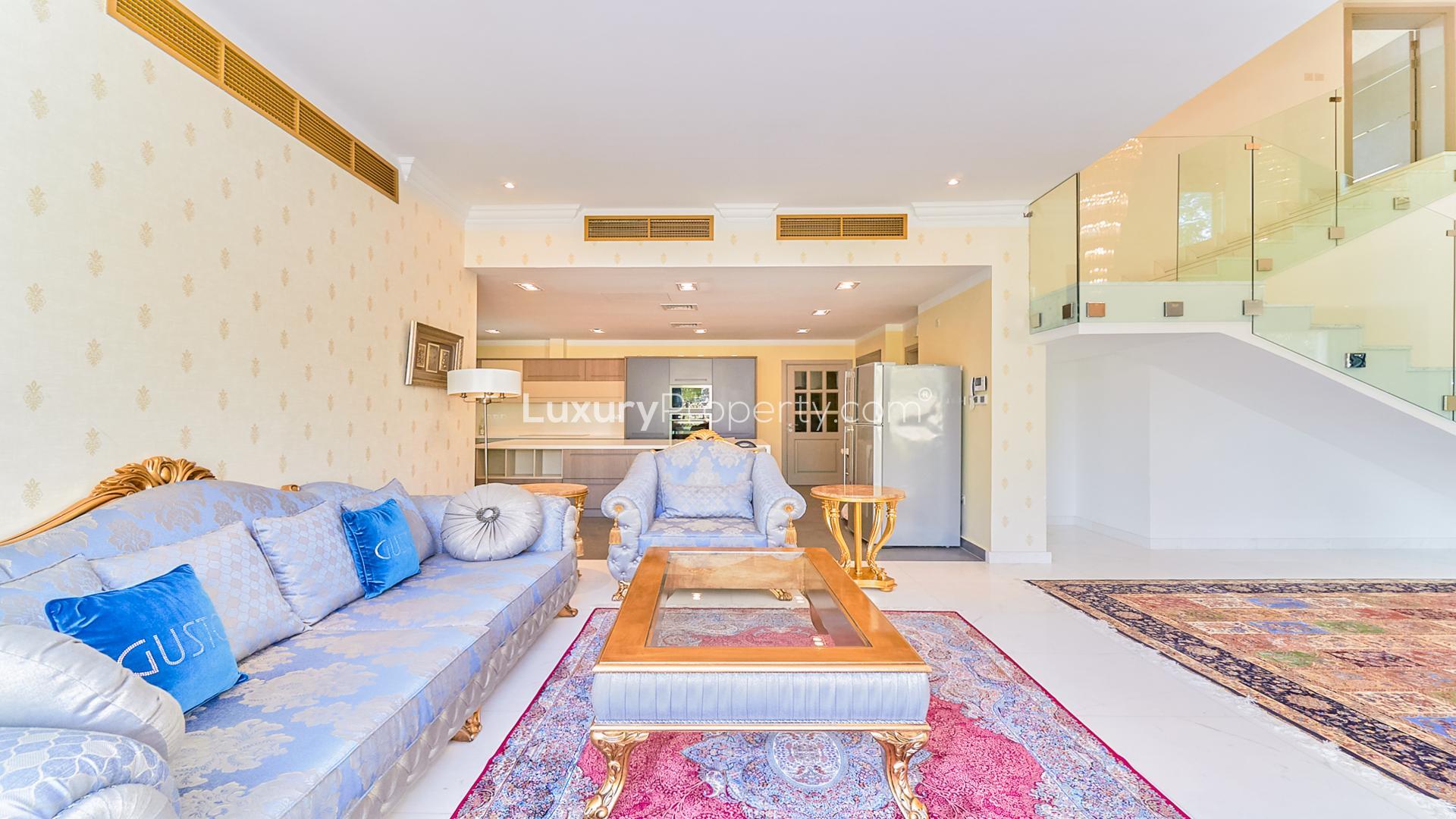 Luxurious living room in upgraded Jumeirah Islands villa with elegant furnishings and large windows