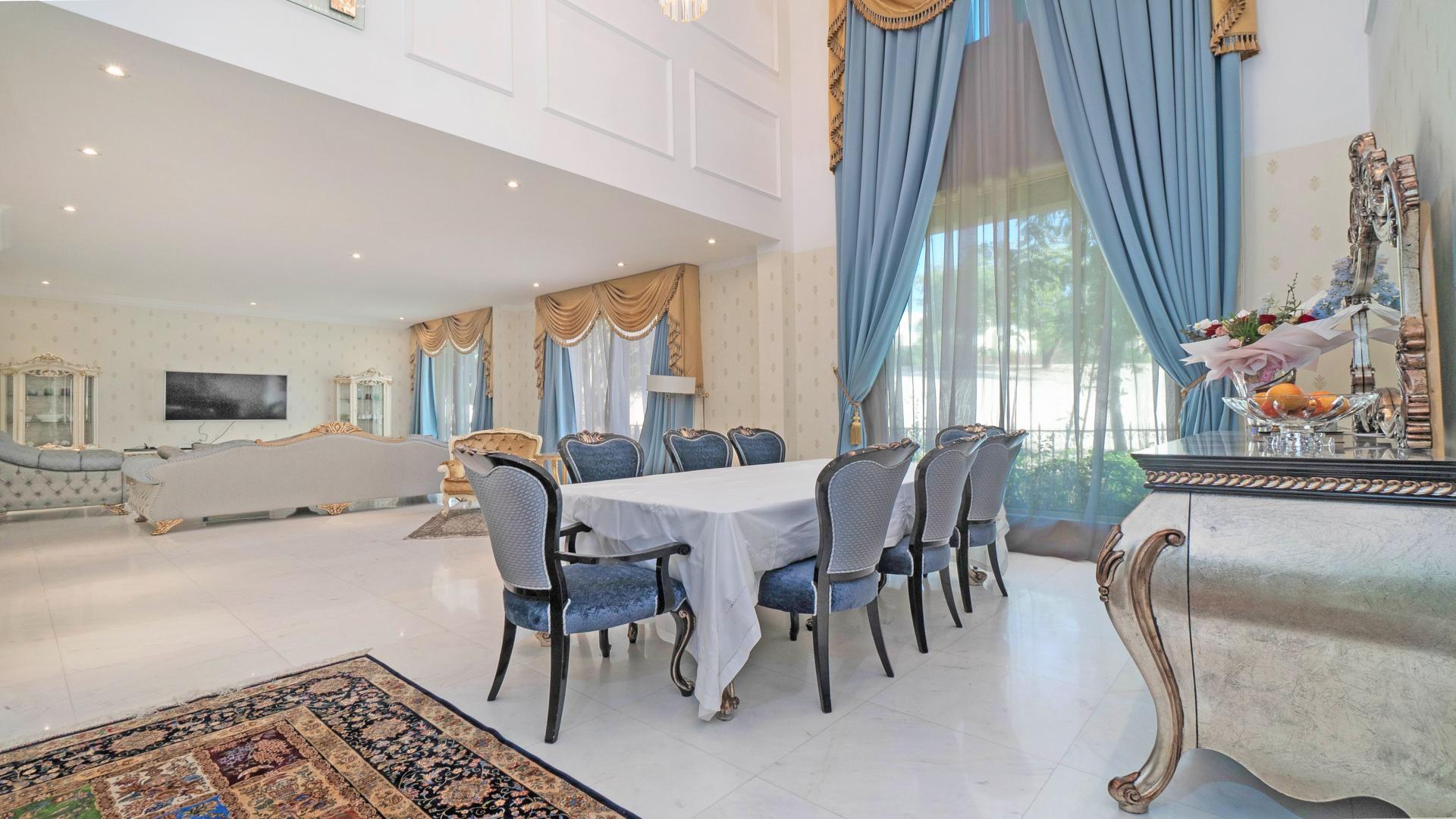Luxurious 5-bedroom villa exterior with landscaped driveway in Jumeirah Islands, Dubai