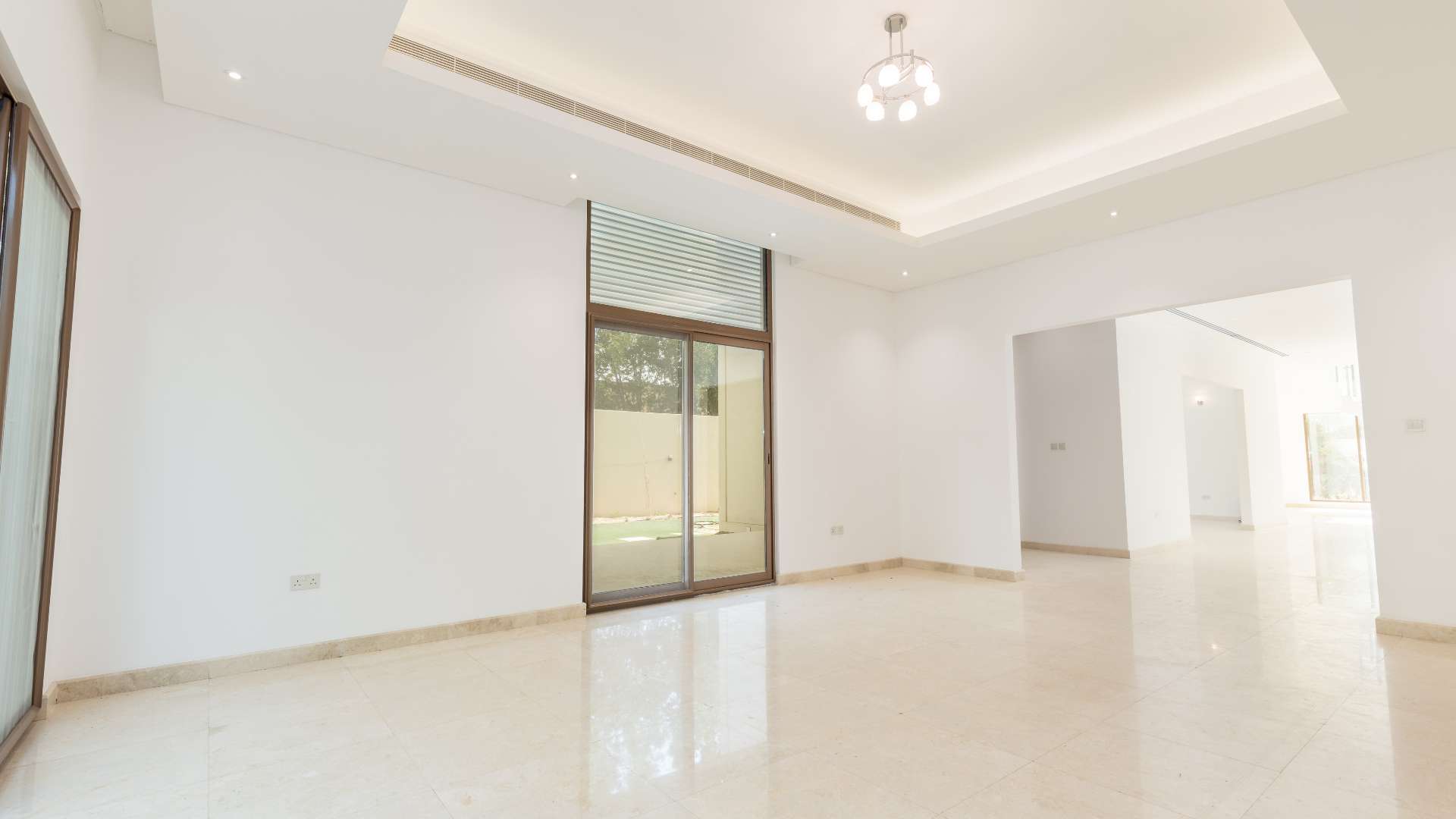 Spacious villa interior with staircase, large windows, and natural light in Meydan Gated Community