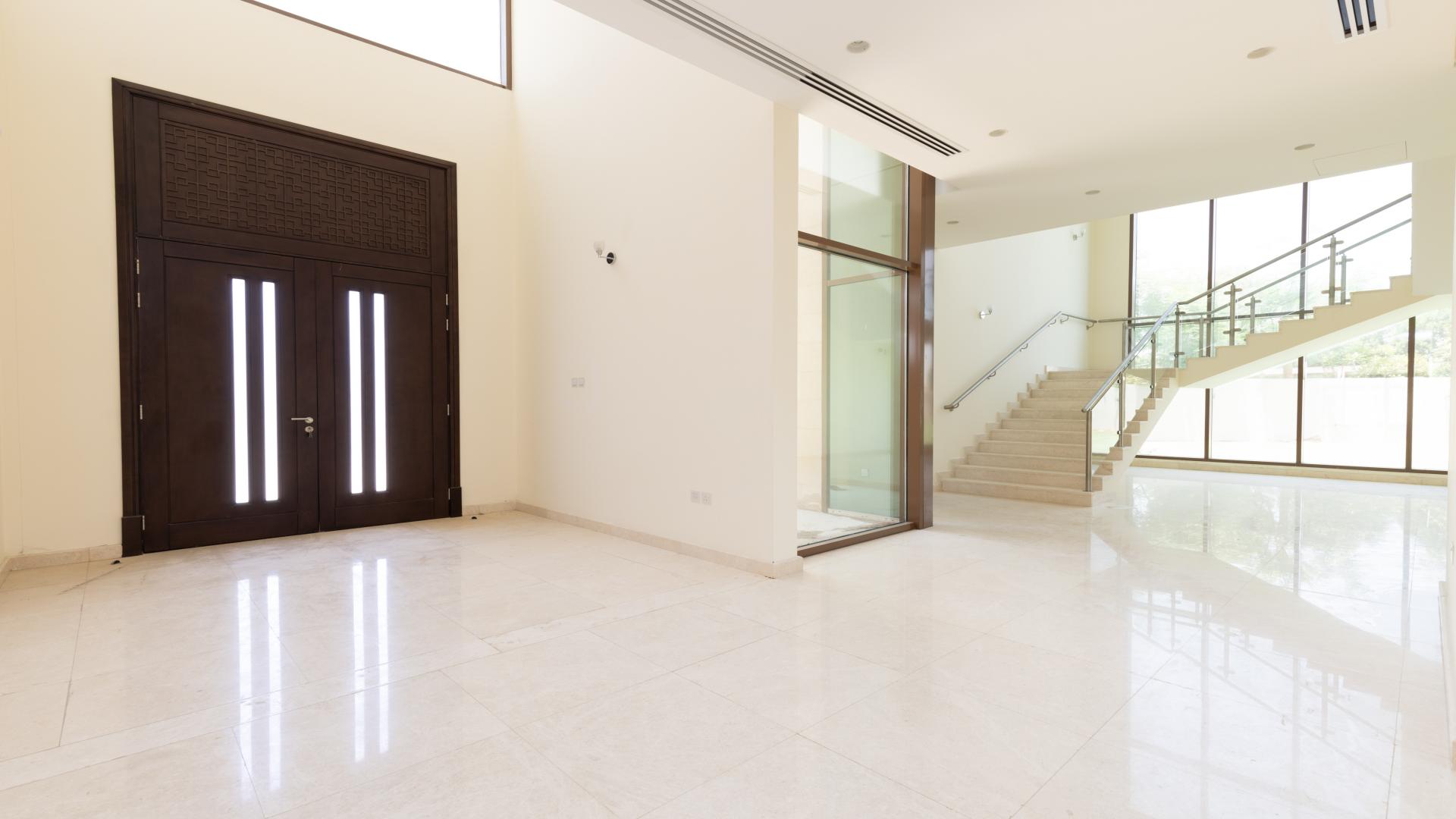 Modern 5-bedroom villa exterior with spacious lawn in Meydan Gated Community, Millennium Estates