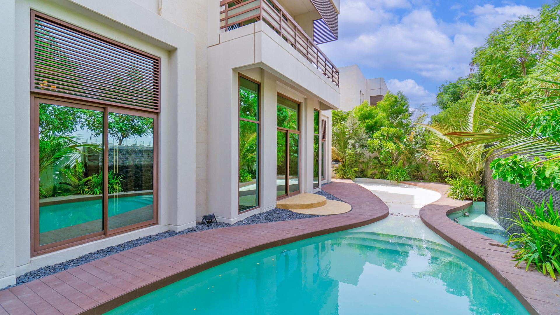 Stunning Meydan villa exterior with trees, showcasing luxury in gated community