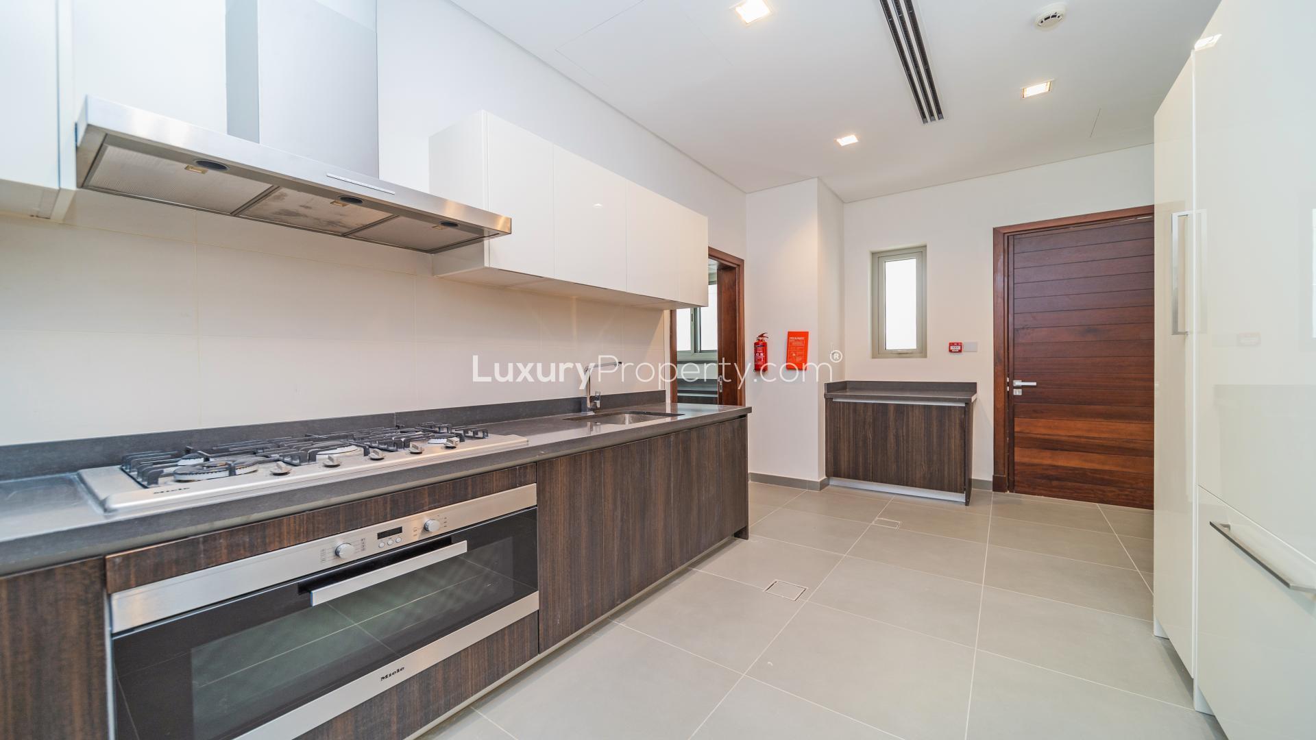 Modern kitchen in luxury 5-bedroom villa, Meydan Gated Community, sleek countertops, spacious layout