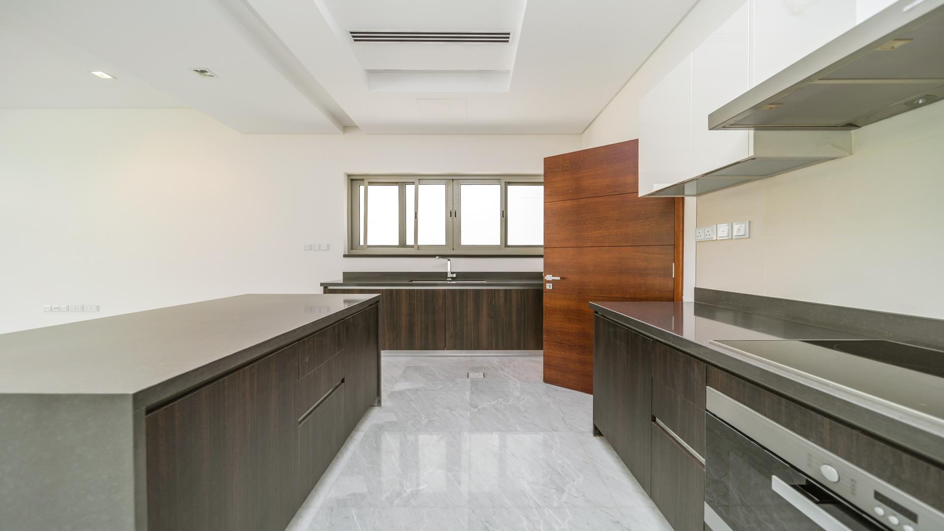 Spacious kitchen and living area in luxury Meydan villa for sale, marble flooring