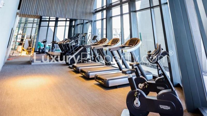 "Spacious villa interior with ocean view, floor-to-ceiling windows in Miami, Florida.",Luxury Miami villa gym with modern equipment, ocean view, Biscayne Boulevard, for sale