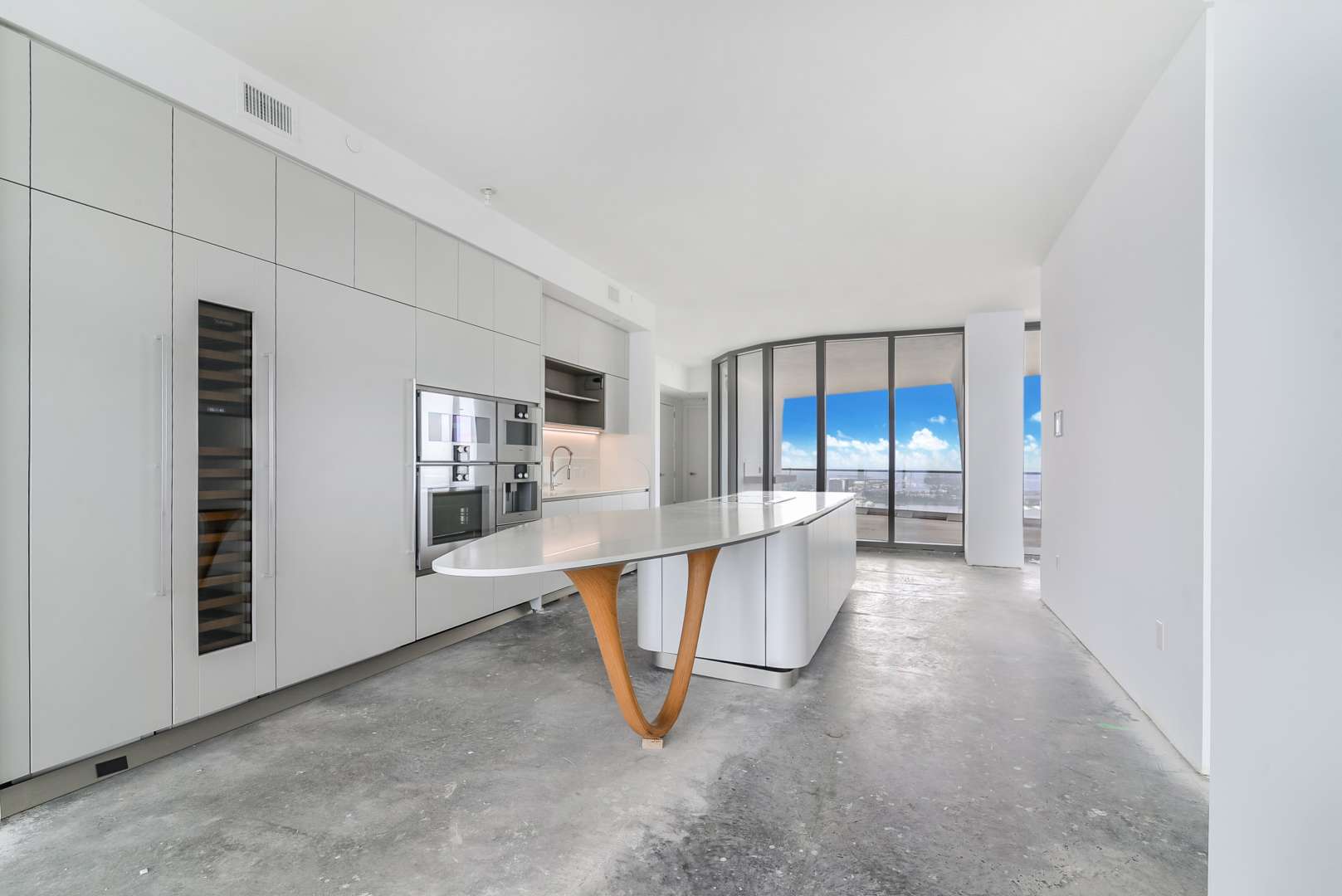 Modern kitchen with island in luxury five-bedroom Miami villa for sale, sky view included