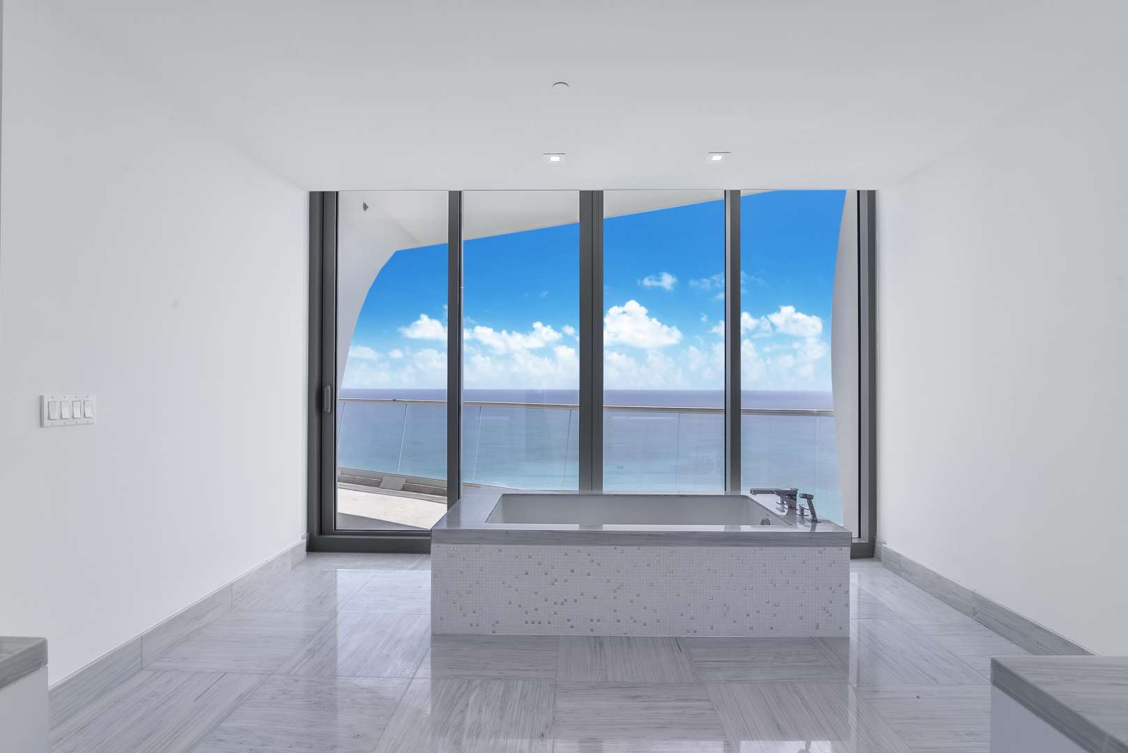 Luxurious Miami villa bathroom with ocean view, featuring modern tub and floor-to-ceiling windows