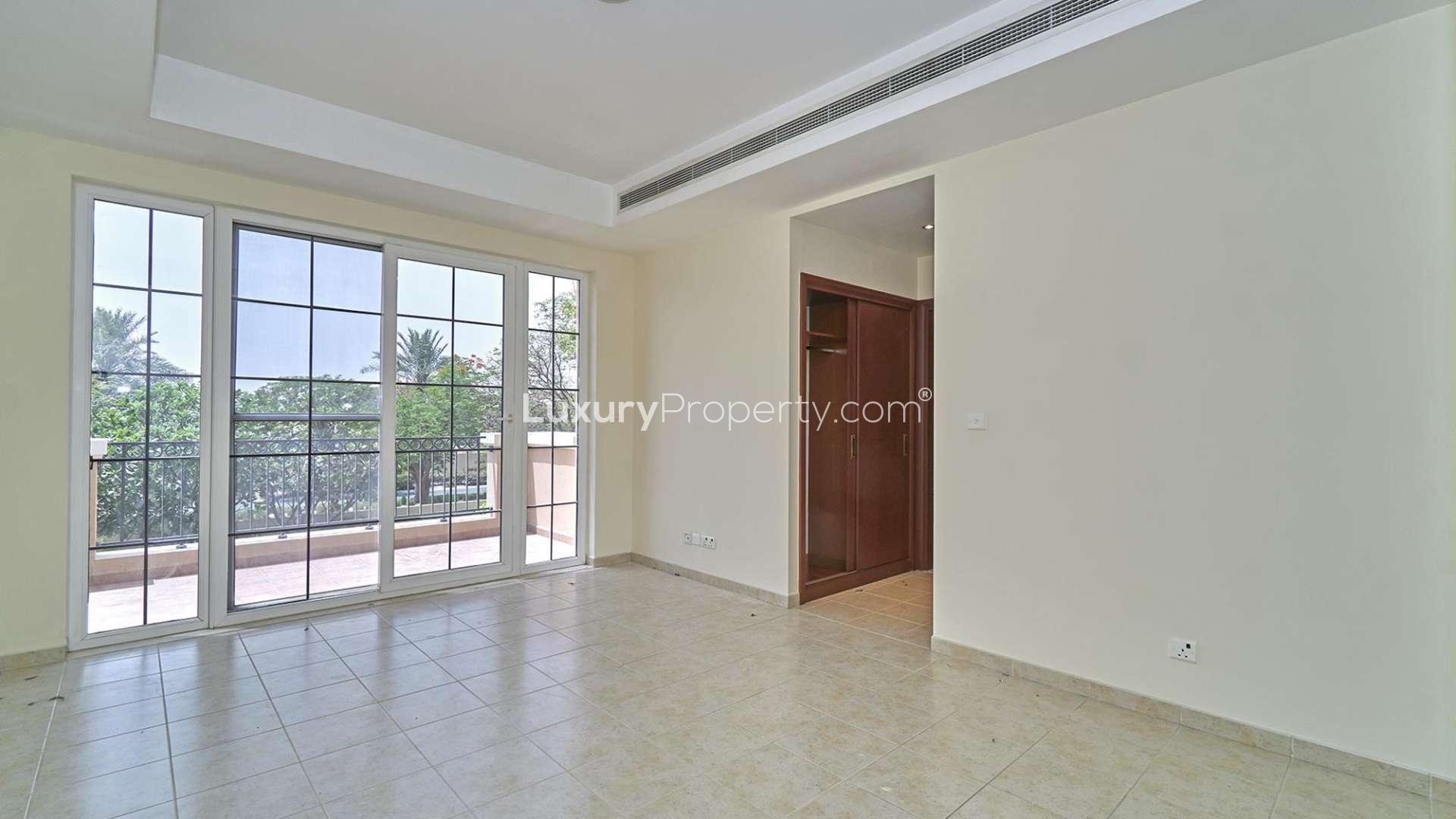 Interior view of villa hallway in Mirador, Arabian Ranches, featuring wooden doors and staircase