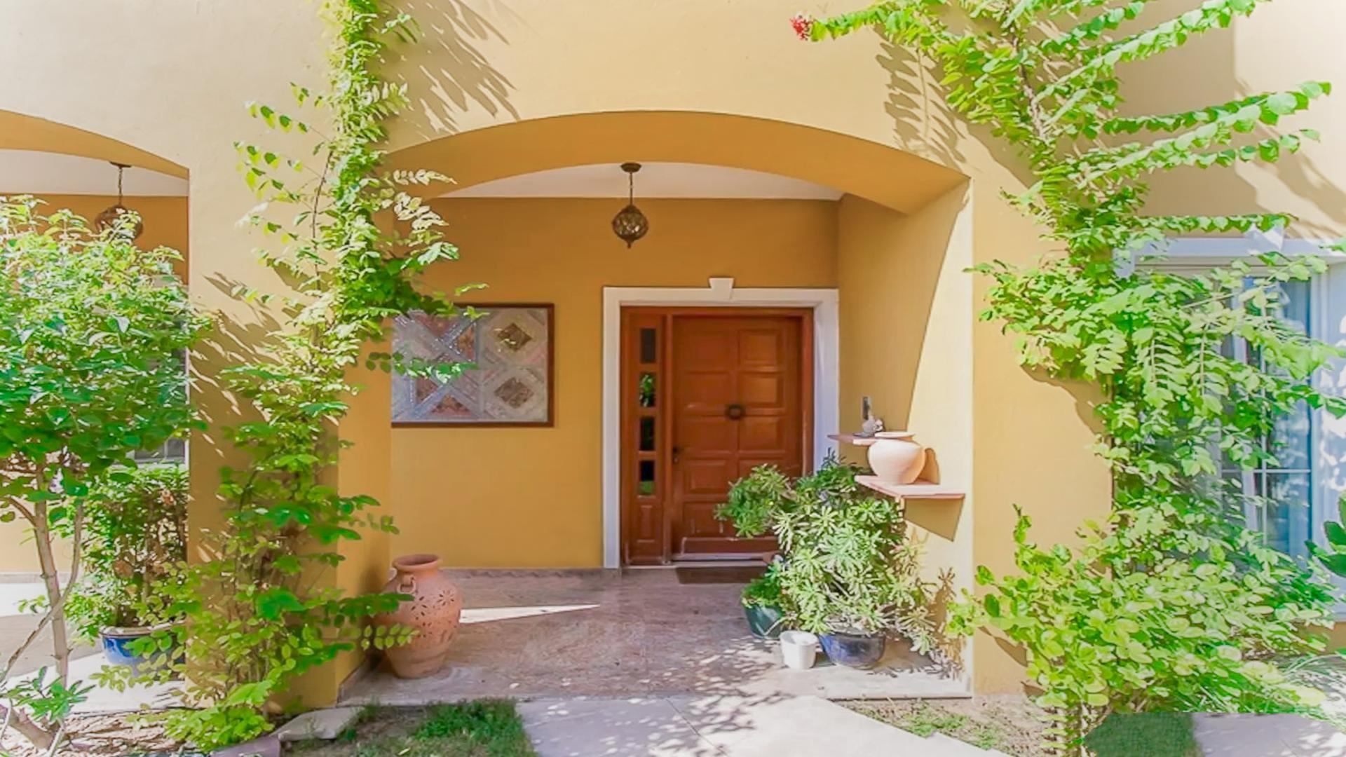 Front entrance of 5-bedroom villa in Mirador, Arabian Ranches with lush greenery