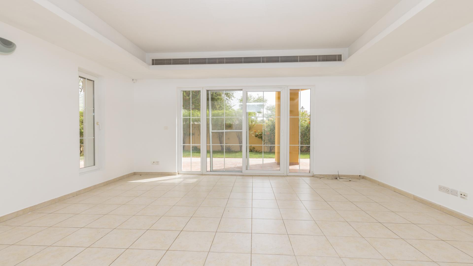 "Luxury villa with pool and gazebo in Mirador, Arabian Ranches, for sale.",Spacious living room with large windows in Mirador villa, Arabian Ranches for sale