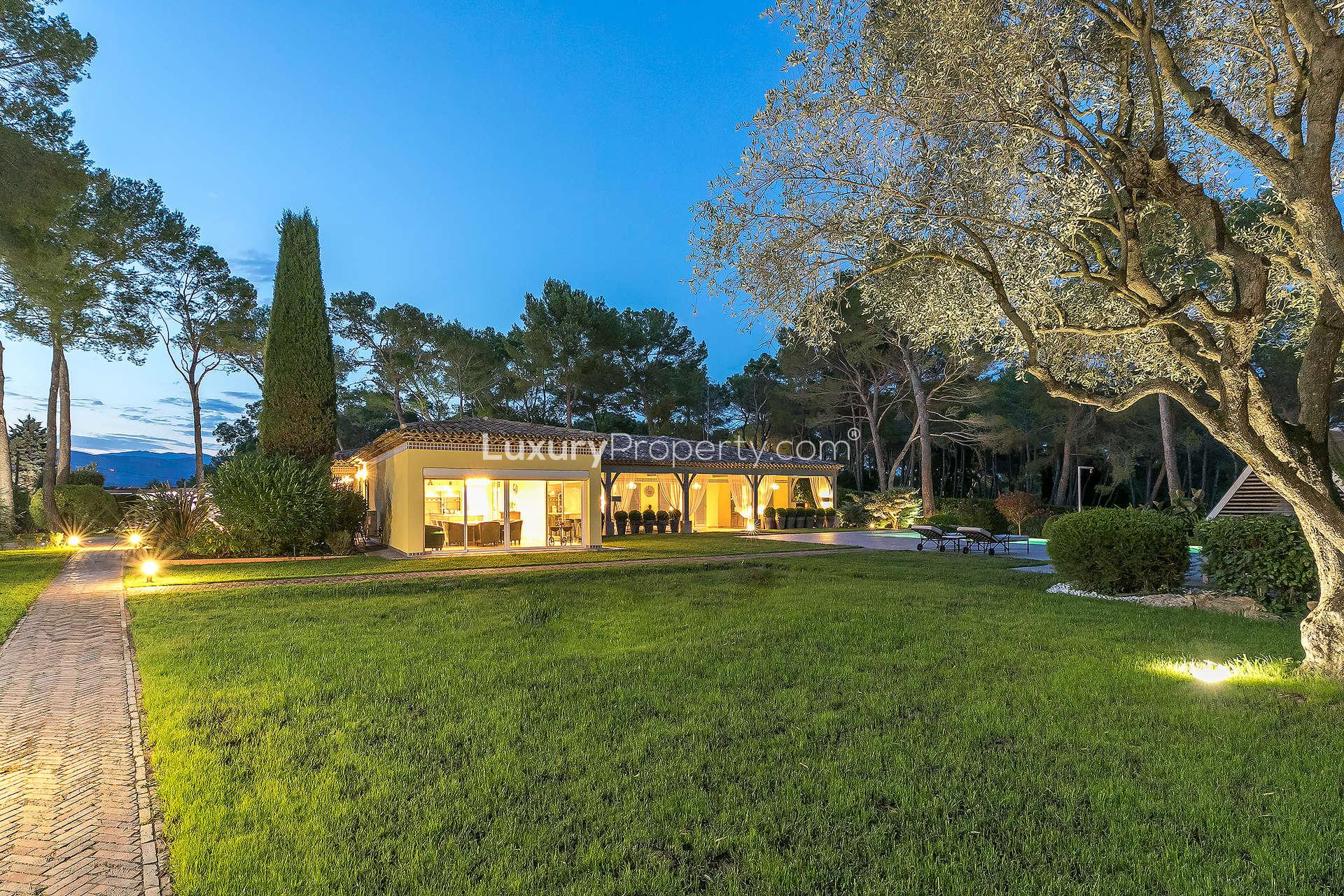 Luxurious villa exterior at night in Mougins, French Riviera, with illuminated pathway
