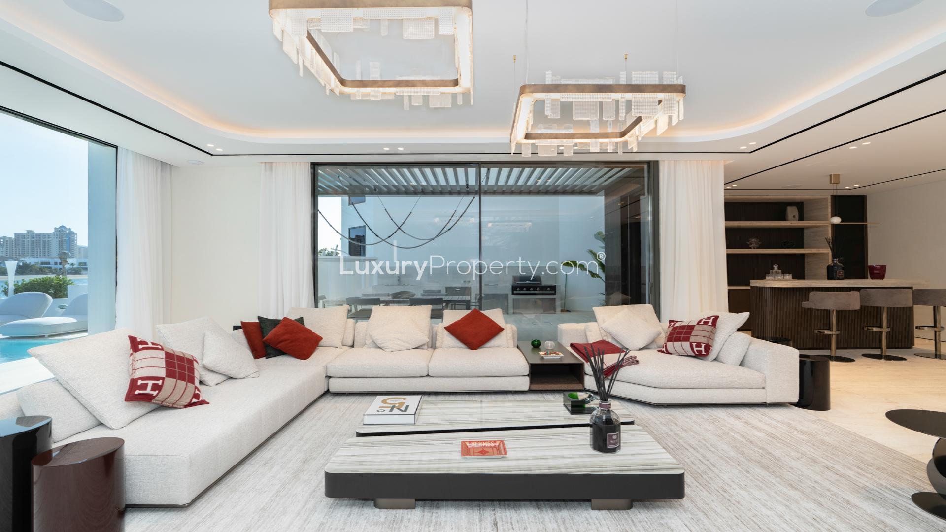 Luxurious living room in upgraded Palm Jumeirah villa with modern decor and pool view